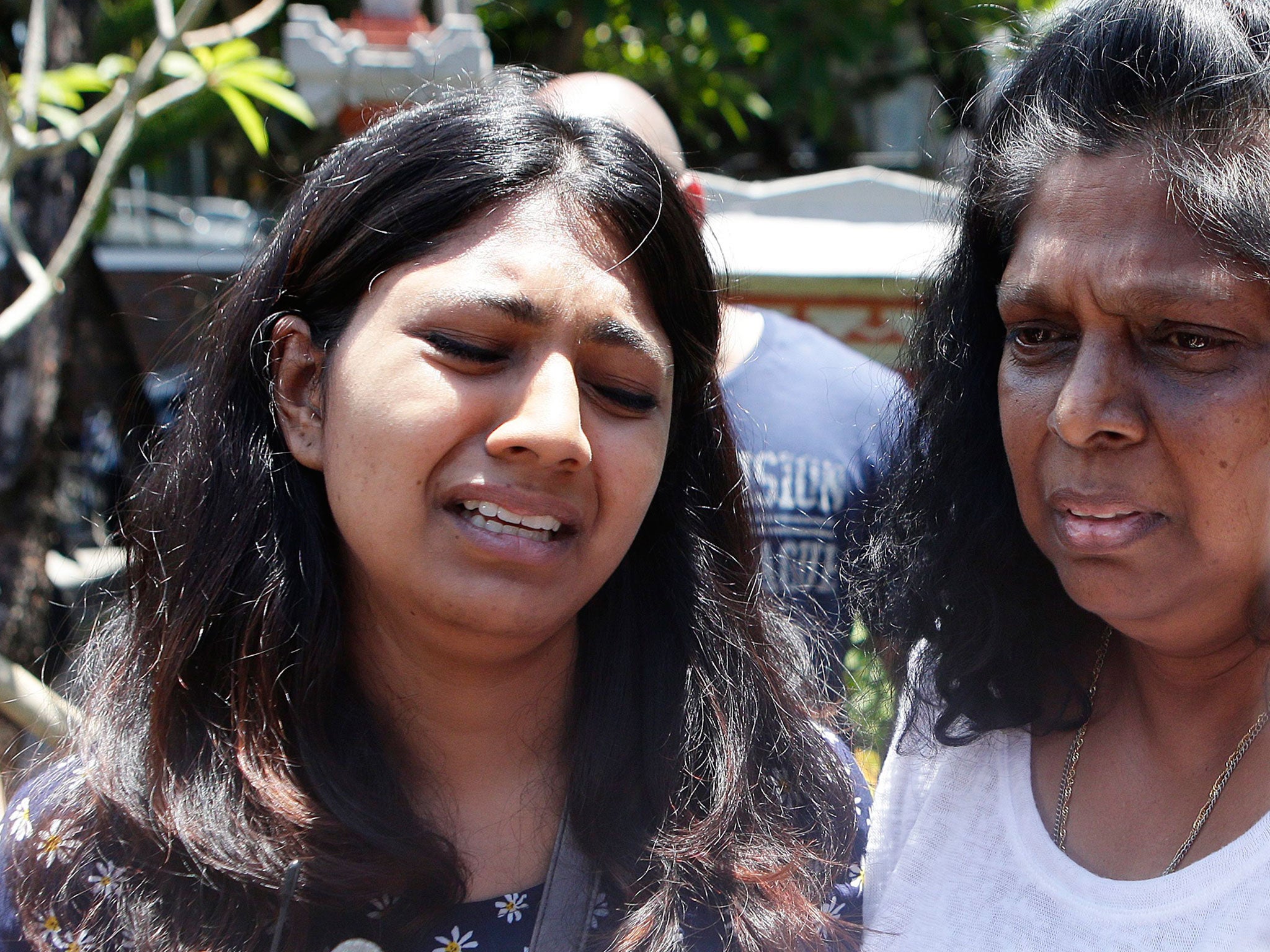 Raji Sukumaran (R) and Brintha Sukumaran (L) family members of death-row prisoner Myuran Sukumaran cries as they talks to media after visiting Myuran at Kerobokan Prison in Bali, Indonesia