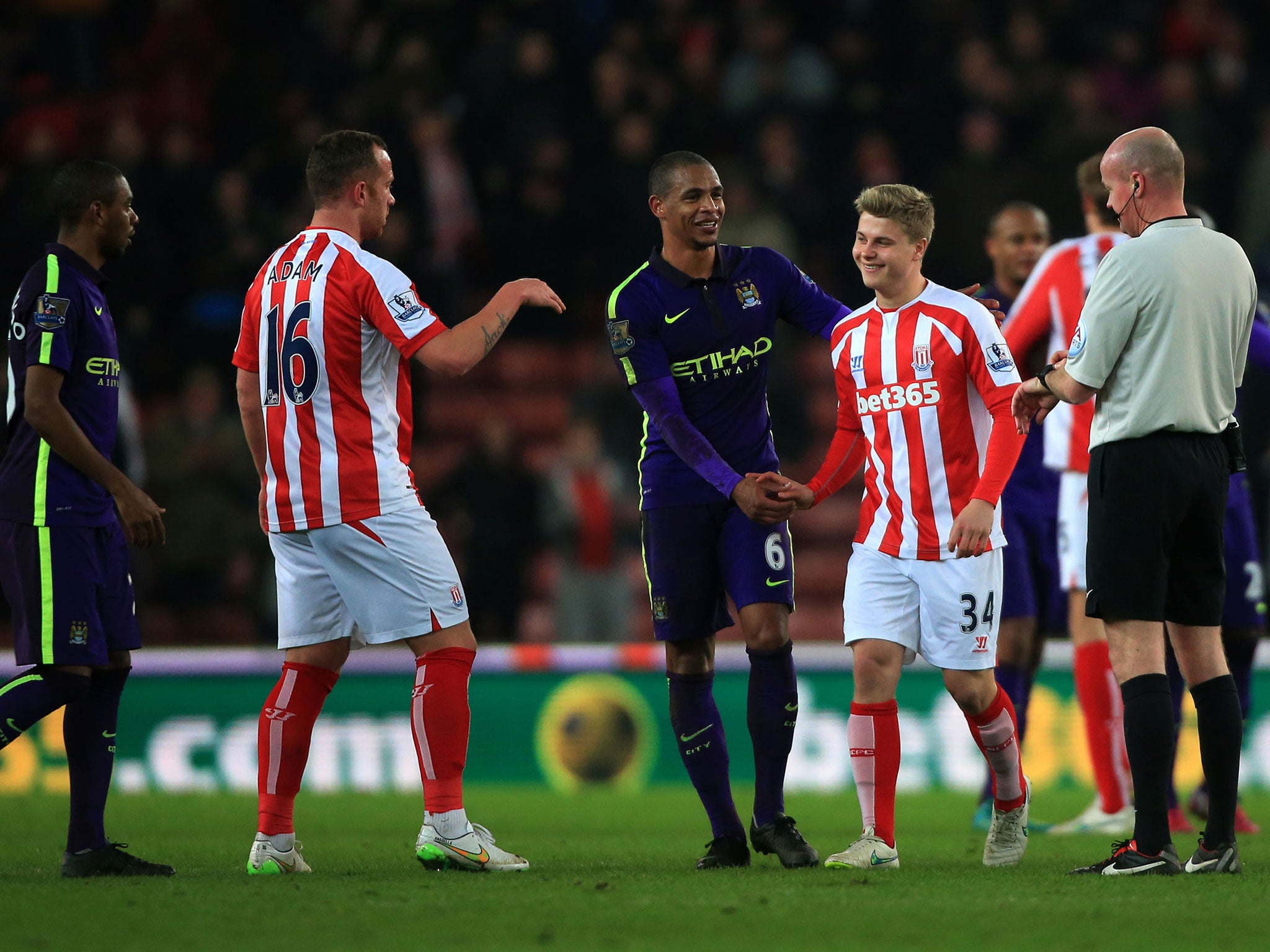 Manchester City's Fernando and Stoke's Charlie Adam congratulate Oliver Shenton after he makes his debut