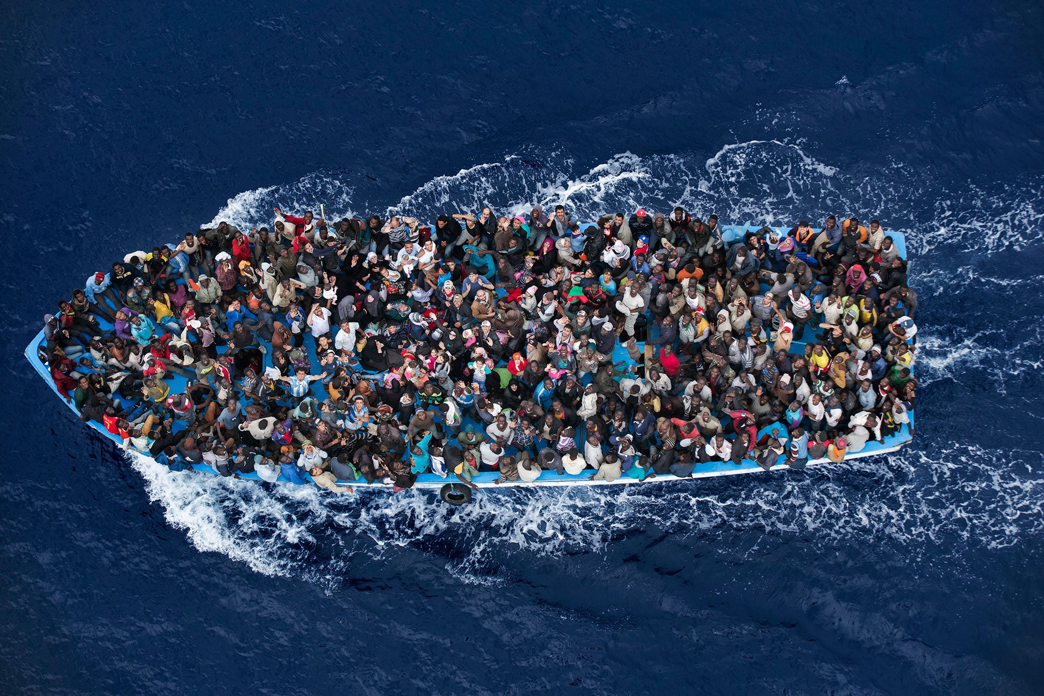 Shipwrecked people are rescued aboard a boat 20 miles north of Libya