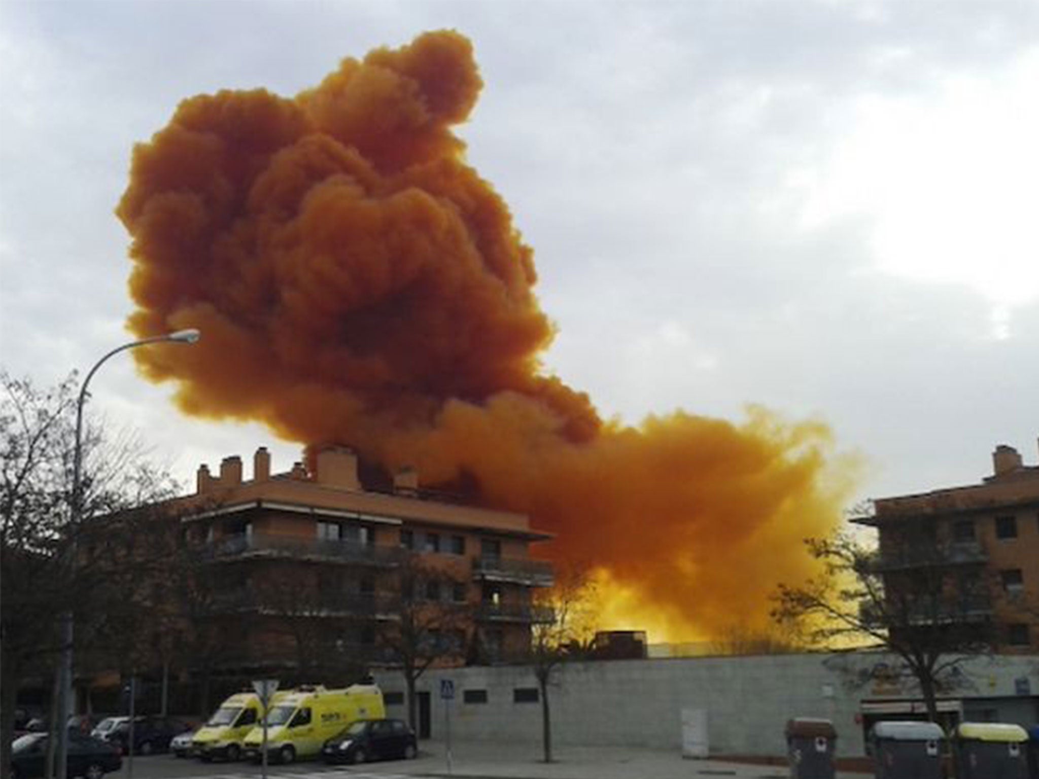 An orange toxic cloud is seen over the town of Igualada, near Barcelona