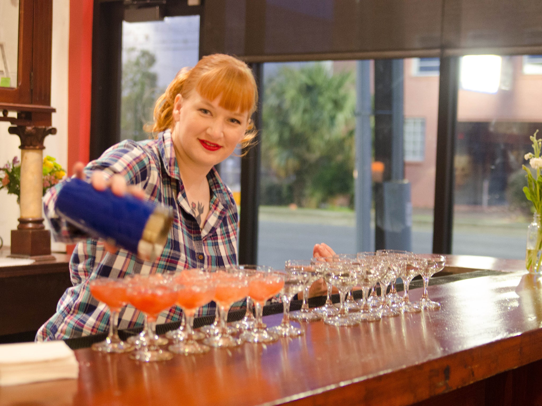 Fancy a cocktail? A waitress pours drinks as a bar in New Orleans