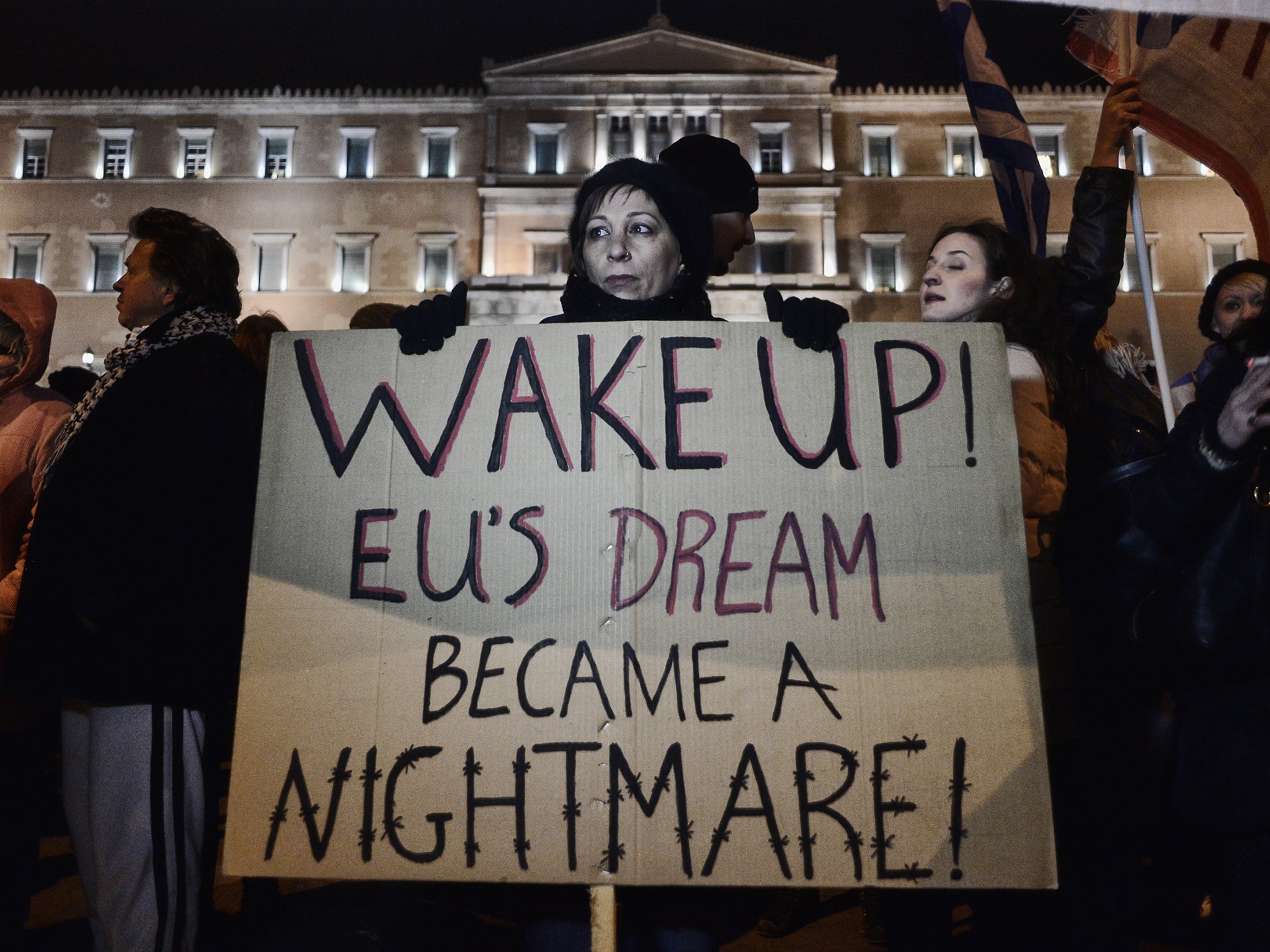 Anti-austerity protesters march outside the Greek parliament in Athens