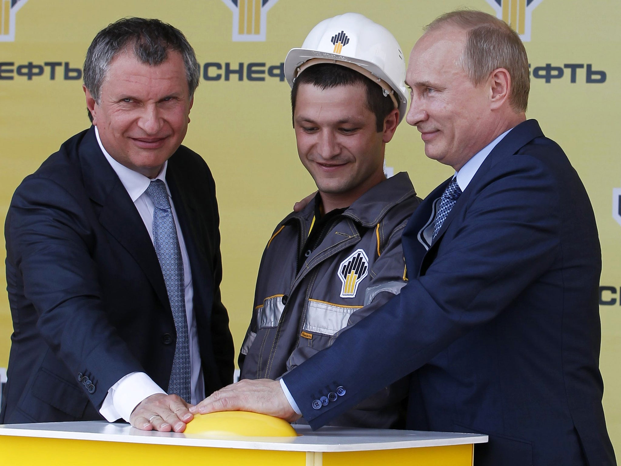 Russia's President Vladimir Putin and Igor Sechin (left) push the button launching a new oil terminal at the Black Sea port of Tuapse in 2012