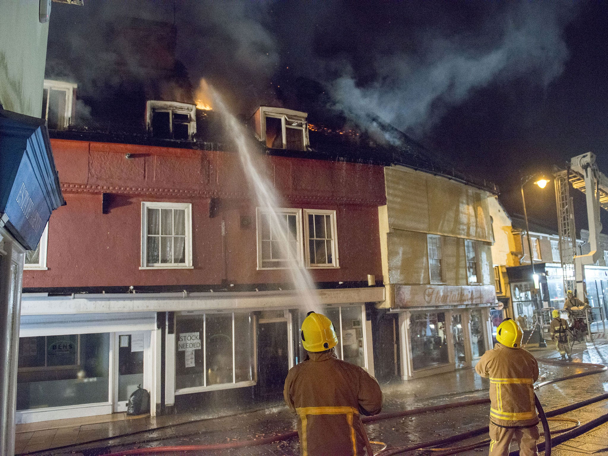 Firefighters at a fire in Braintree, Essex, where a quick-thinking bus driver came to the rescue by manoeuvring his vehicle to help a naked man escape from the burning building (Photos: Essex Fire and Rescue Service/PA Wire)