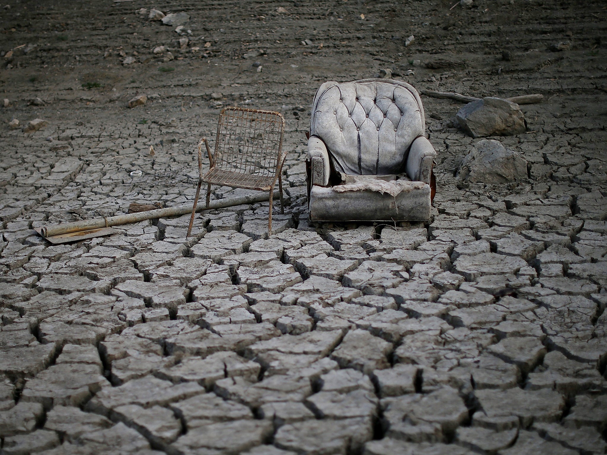 Chairs sit in dried and cracked earth that used to be the bottom of the Almaden Reservoir in San Jose, California. The state is experiencing its driest year on records that date back 119 years