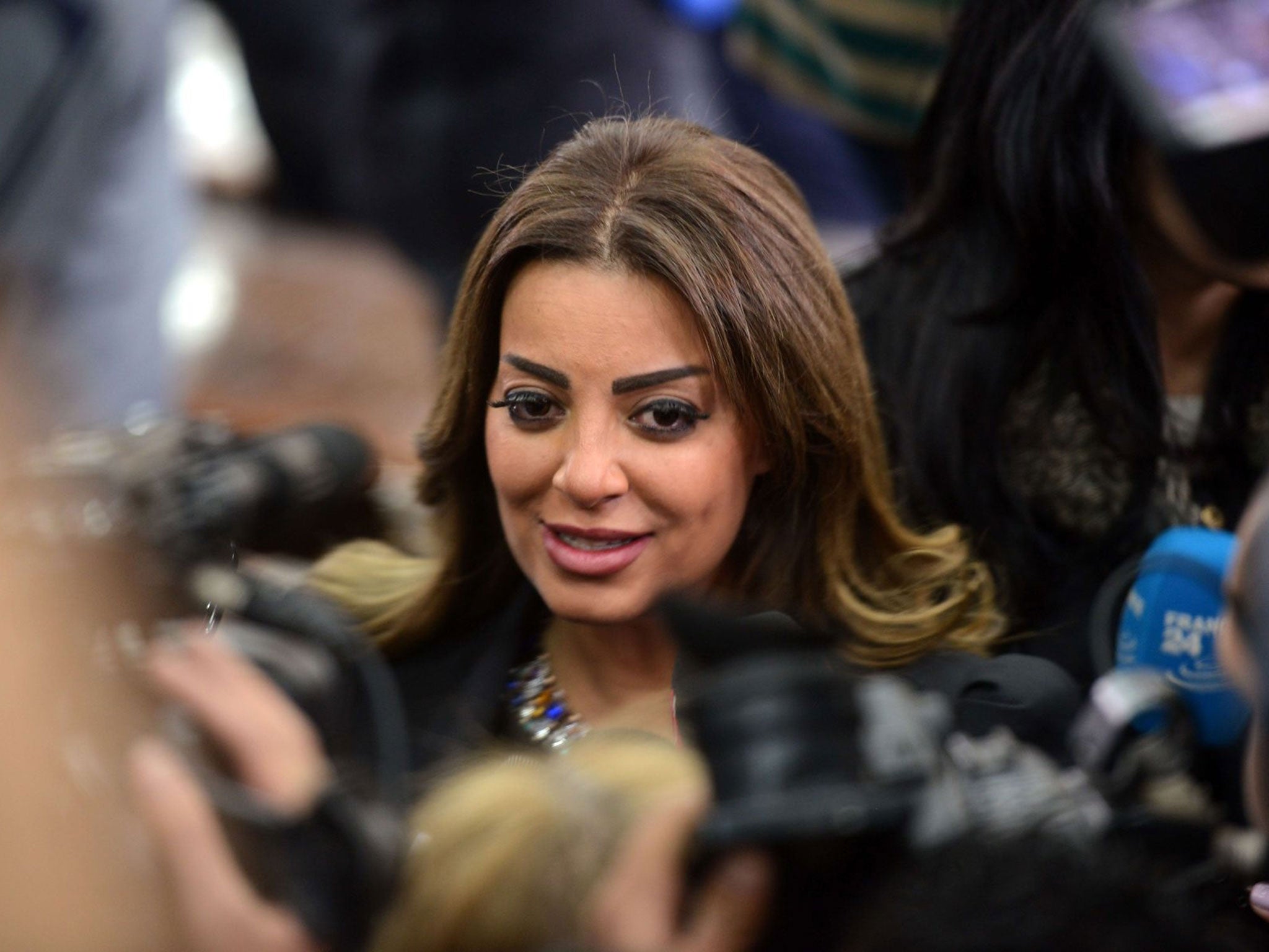 Marwa Emara, the fiancé of Mohamed Fahmy stands next to reporters at the court in Cairo