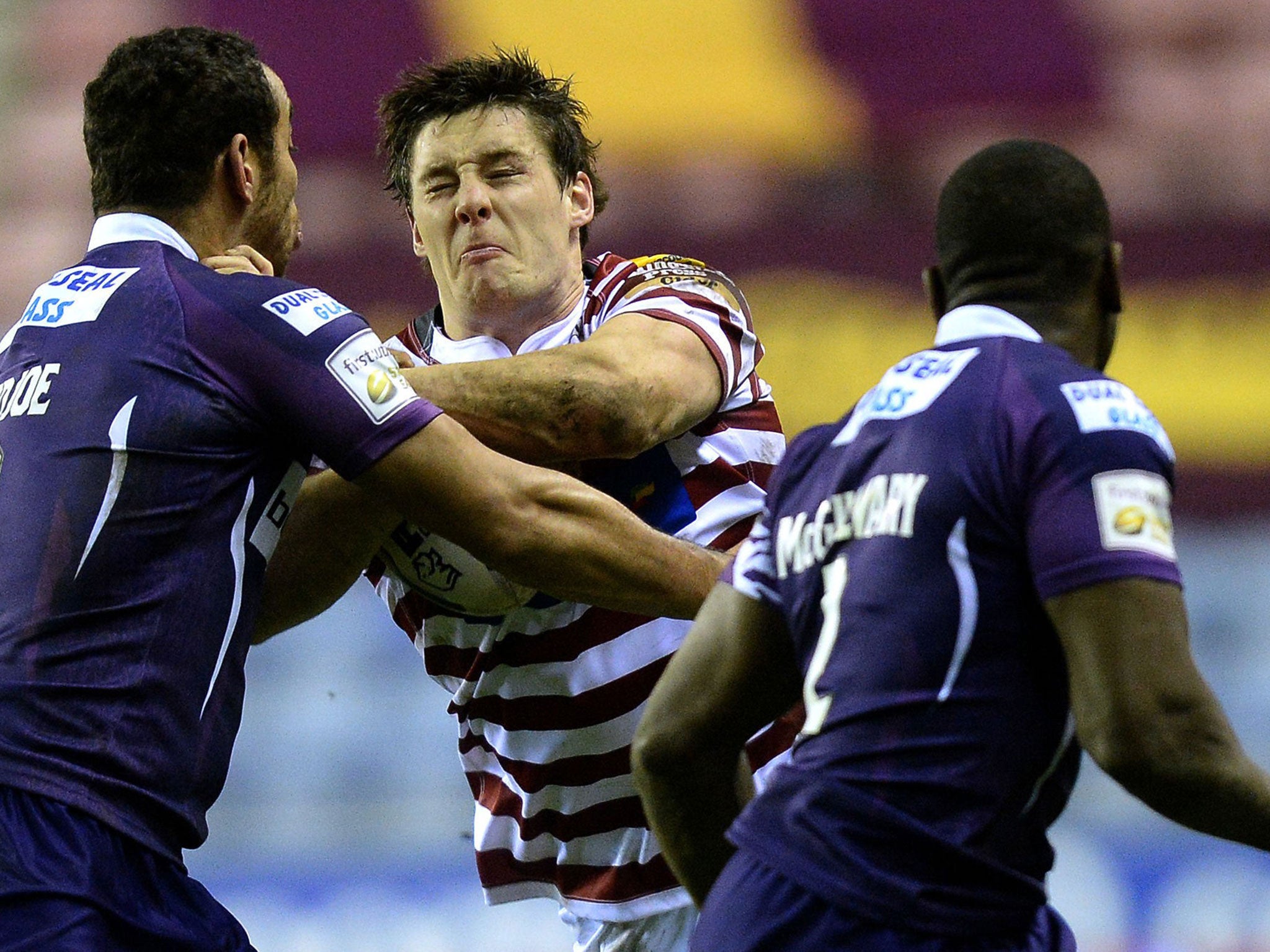 Joel Tomkins scored two tries as Wigan battled back to beat Huddersfield 24-16 last night