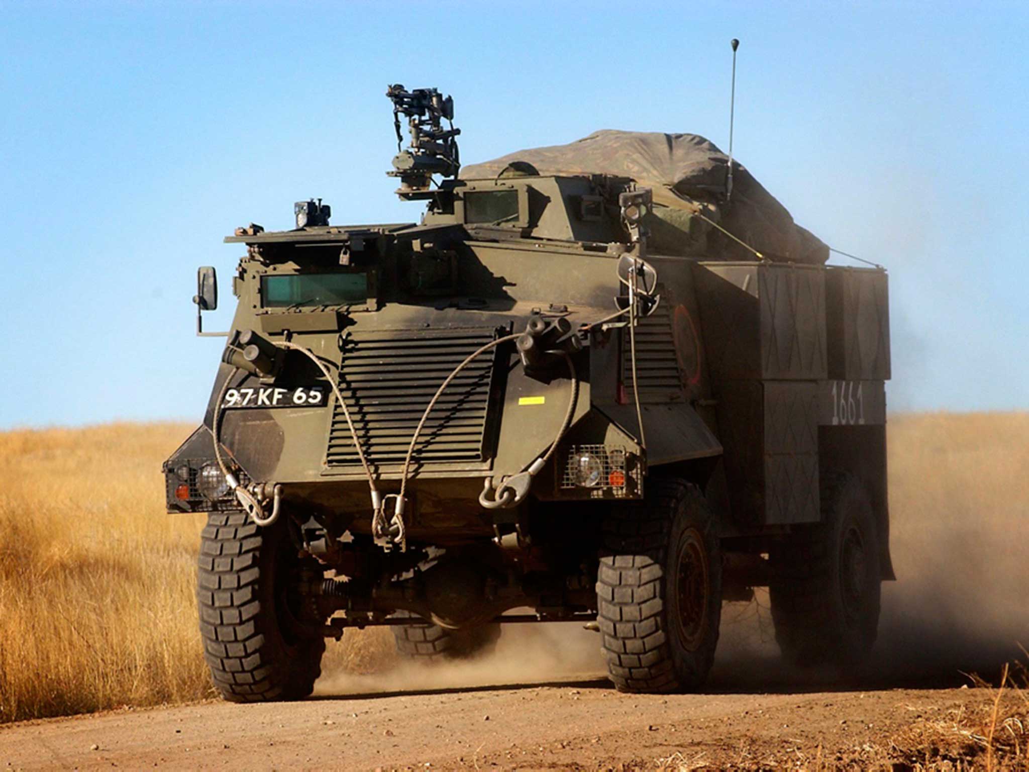 A Saxon Armoured Personnel Vehicle from the Cheshire Regiment moves at speed into battle during an exercise in Canada in 2003