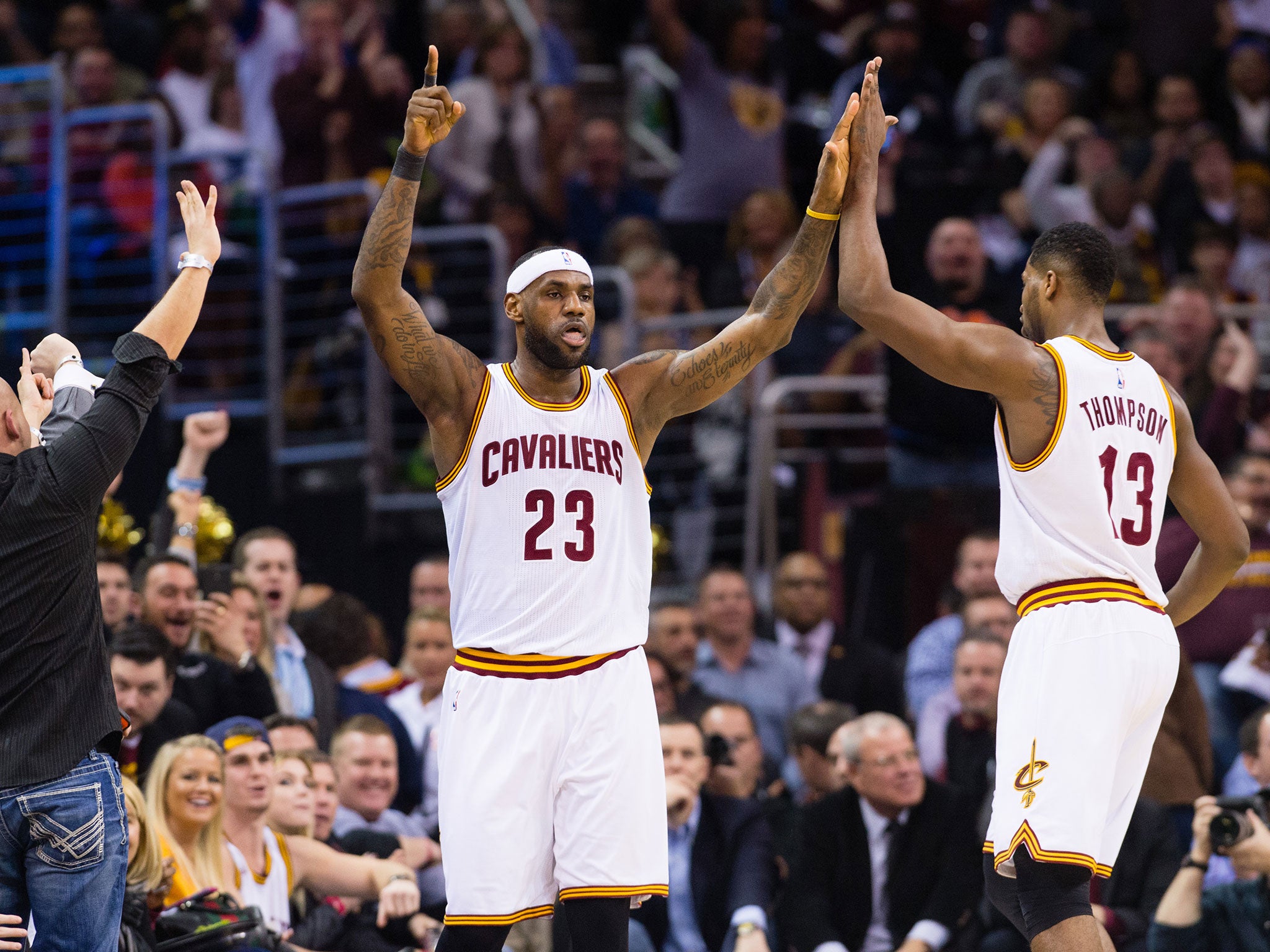 LeBron James celebrates with Tristan Thompson after James scored during the first half against the Miami Heat