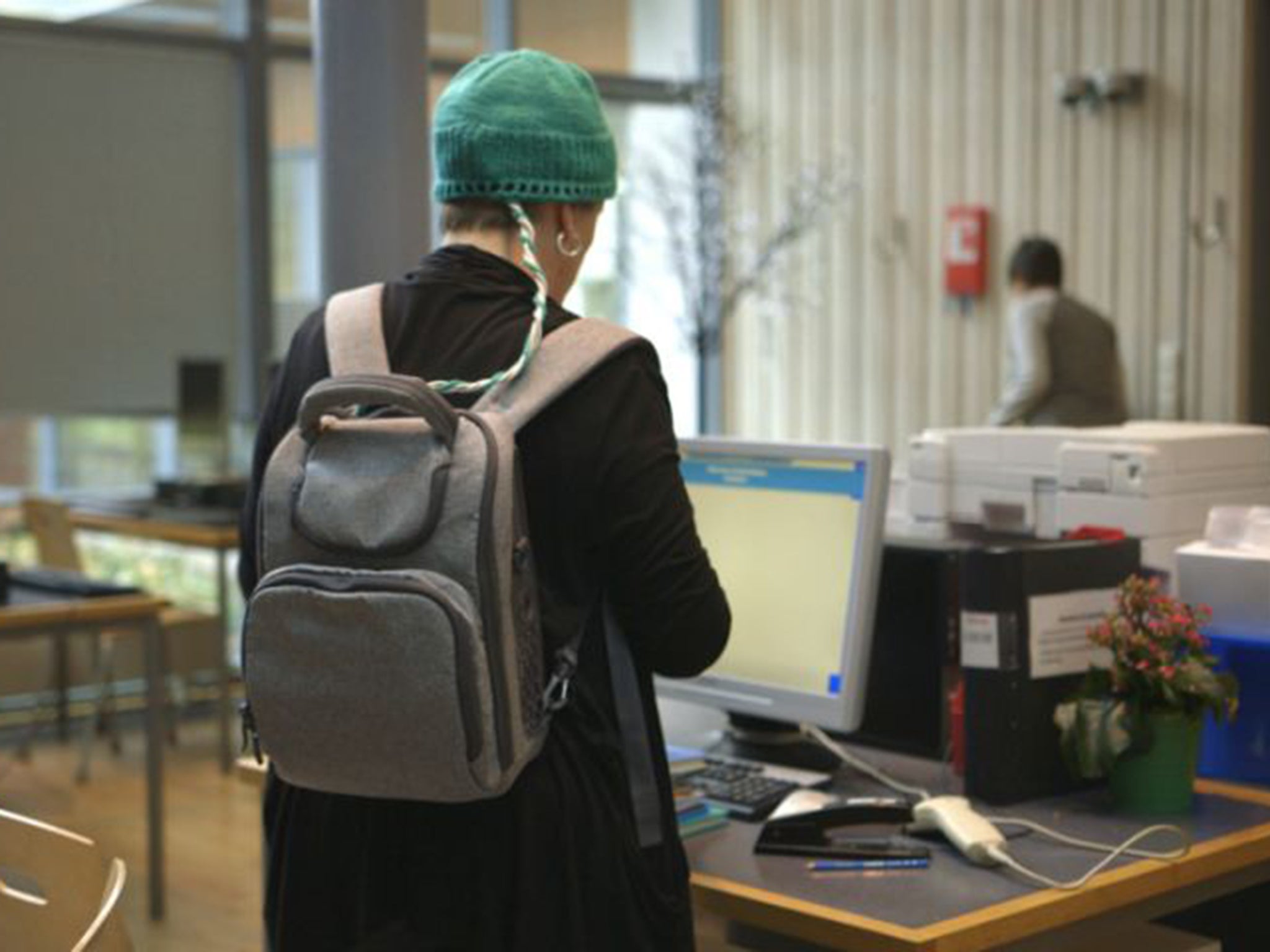 The cap is wired to a battery pack and emits an electrical field into the brain