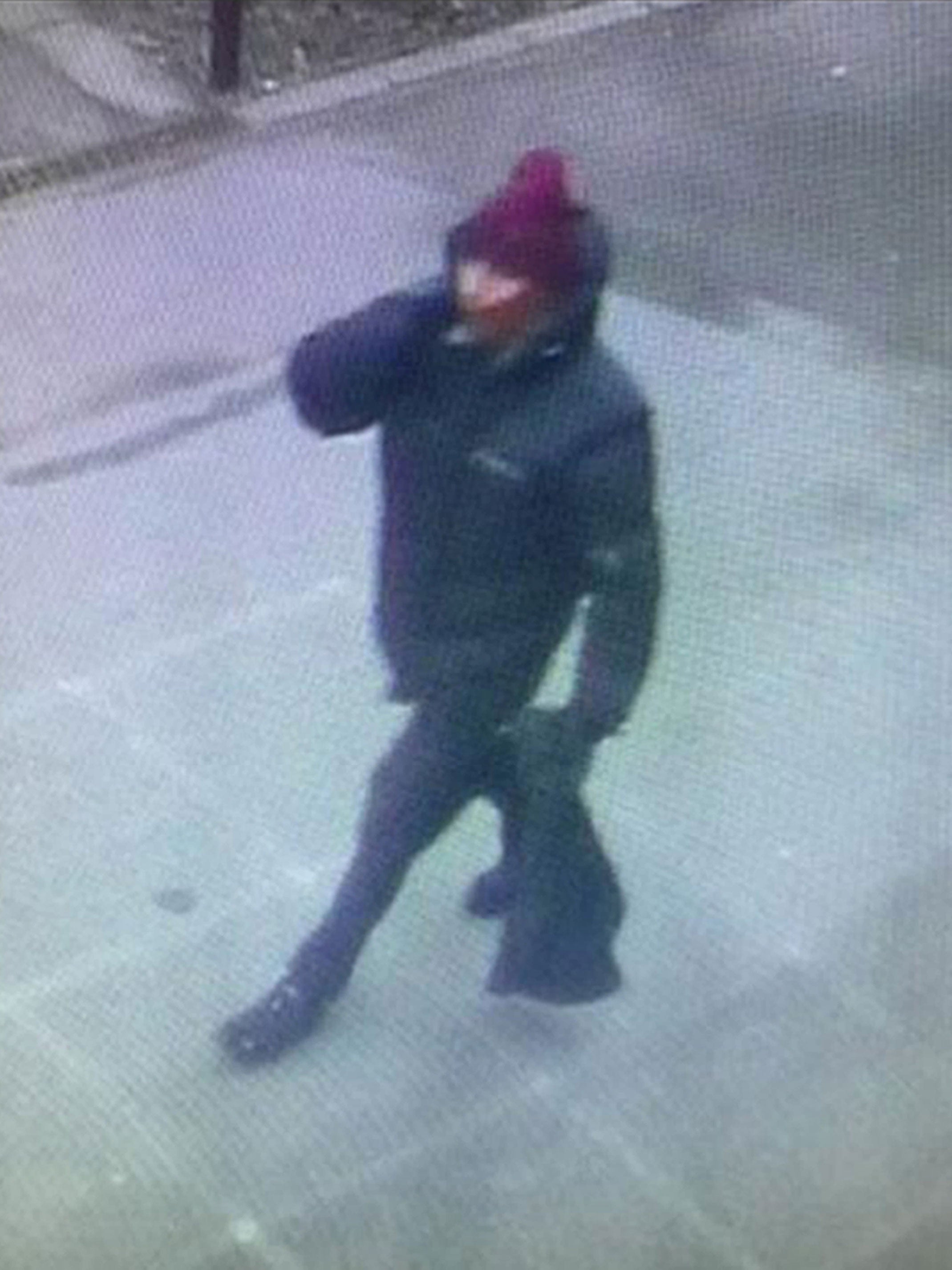 Police-issued image of the suspect gunman, wearing dark clothes and a scarf over his face