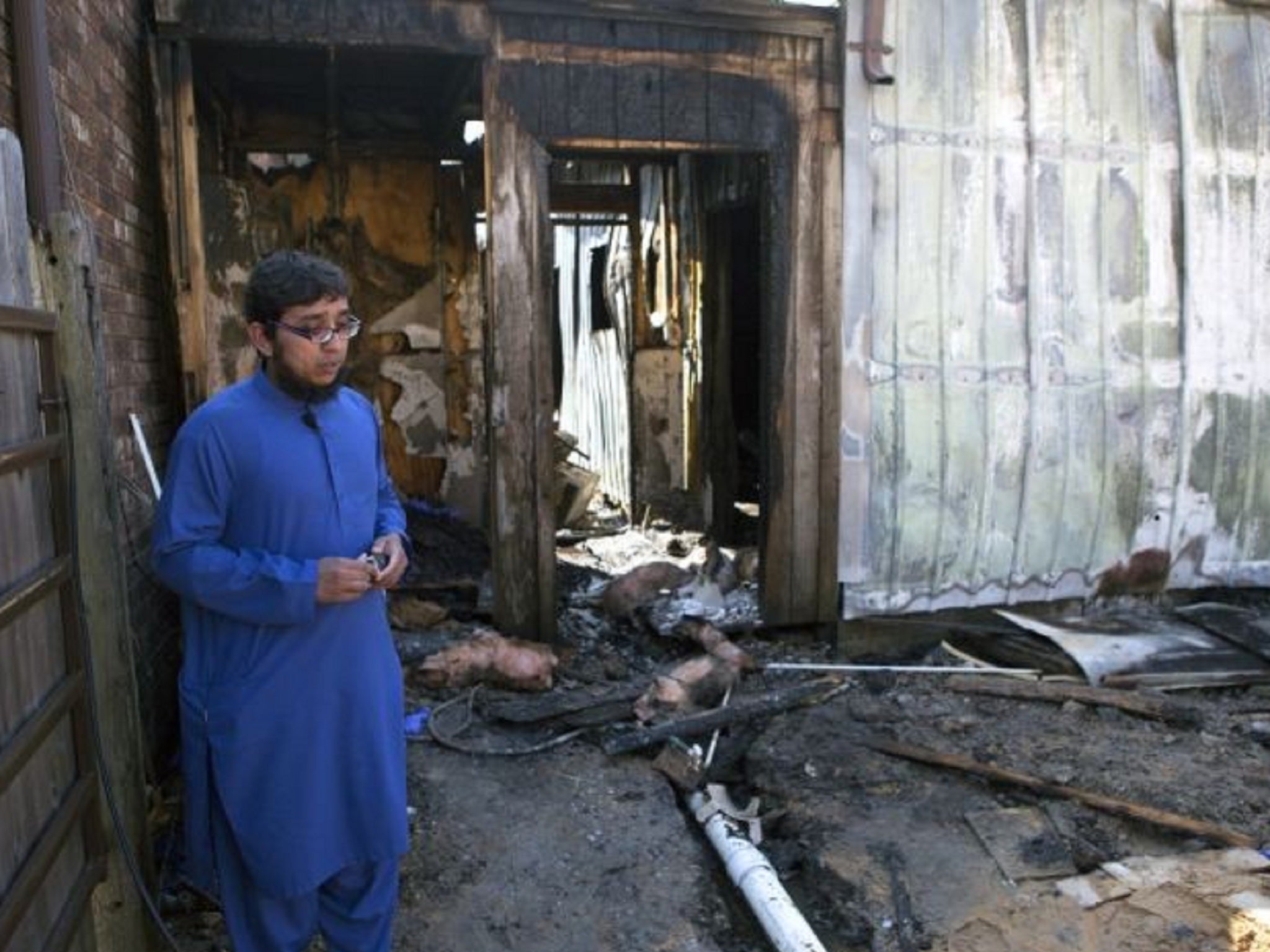 Ahsan Zahid looks at the ruined building that housed computers and building materials