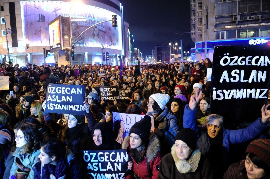 Women shout slogans and hold placards reading "Ozgecan Aslan is our rebellion" during a demonstration in Istanbul