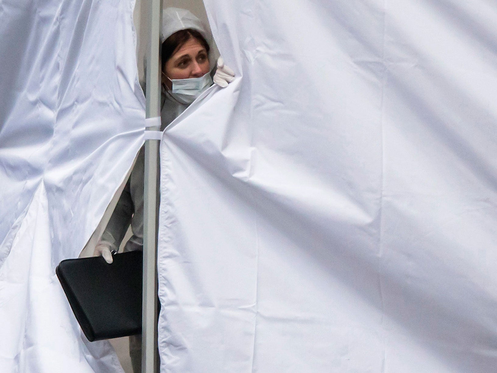 Forensic experts work at the site where a man was killed by police close to Norrebro Station