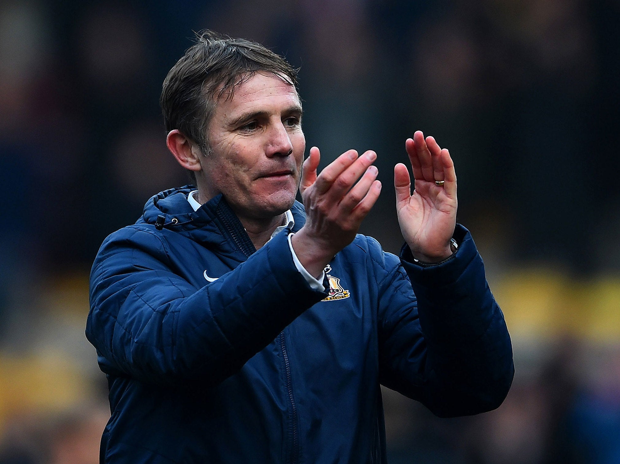 Phil Parkinson applauds the Bradford fans after the memorable win