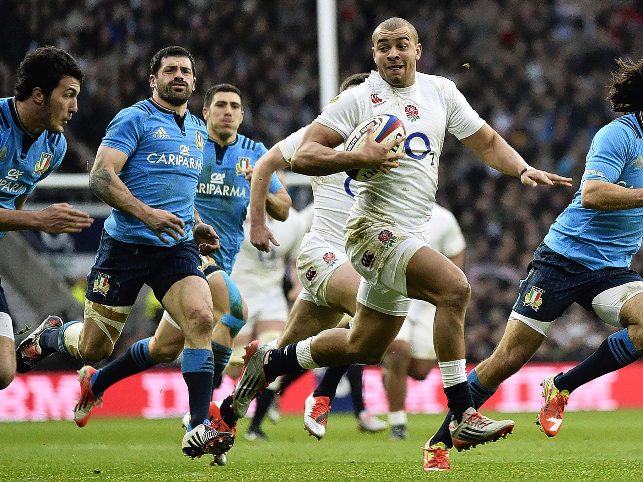 Jonathan Joseph breaks through the Italian defence to score the first of his two tries for England on Saturday