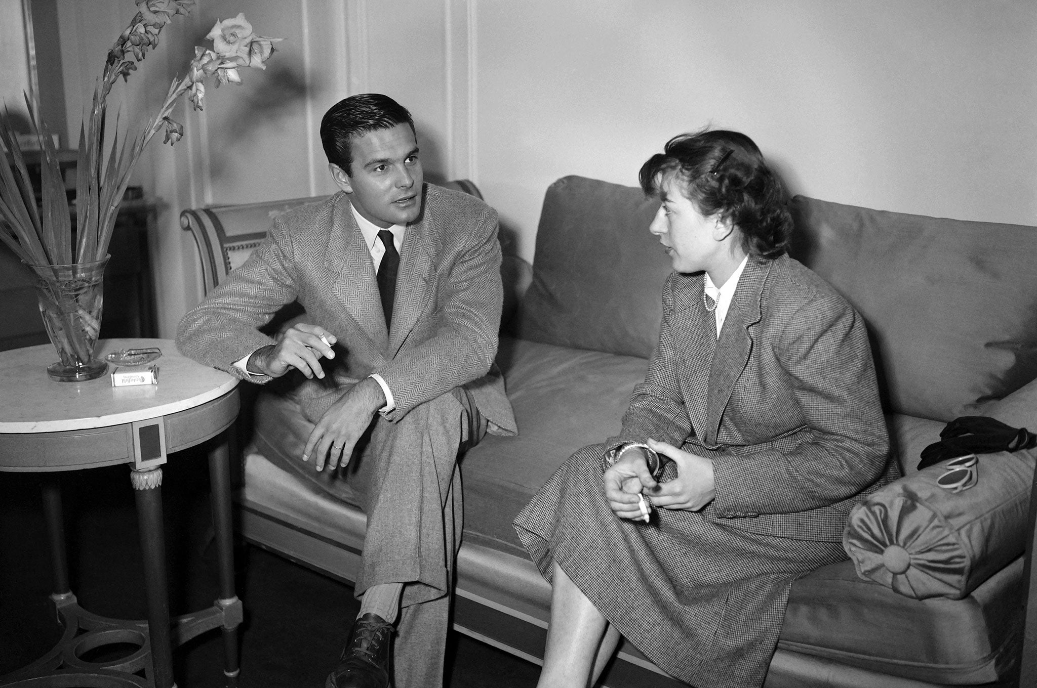 Louis Jourdan (L) in June 1949 speaking with a friend at a party in Hollywood