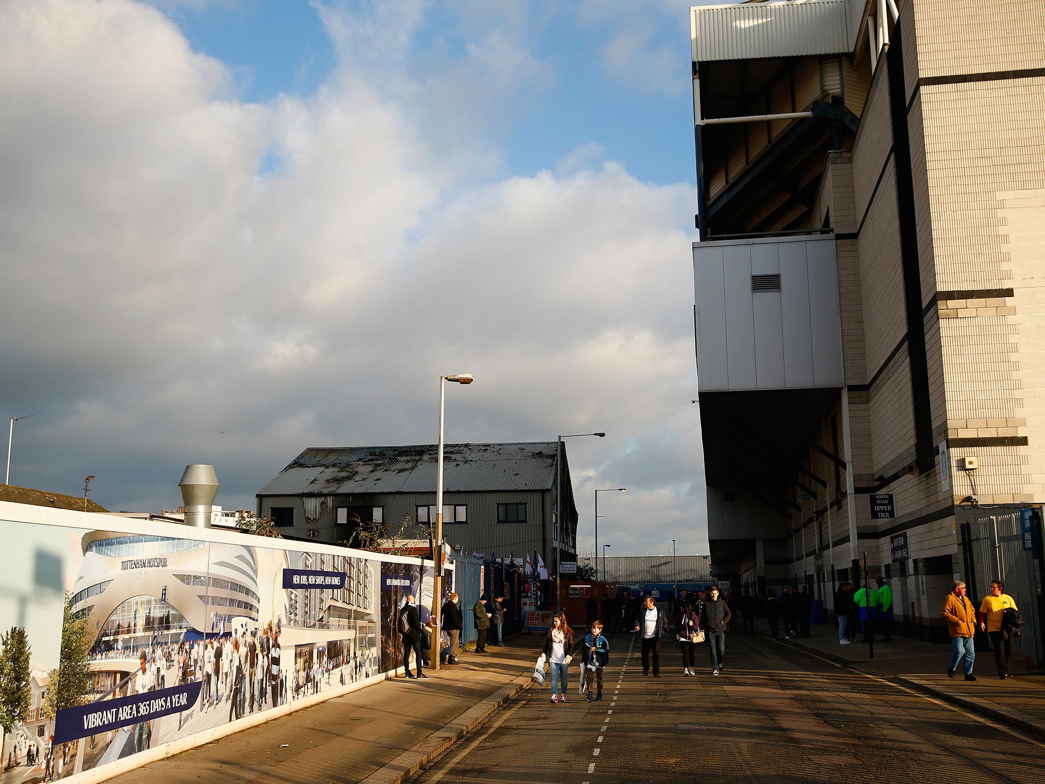 A sign for the new ground development is seen next to the fire damaged Archway Sheet Metal Works