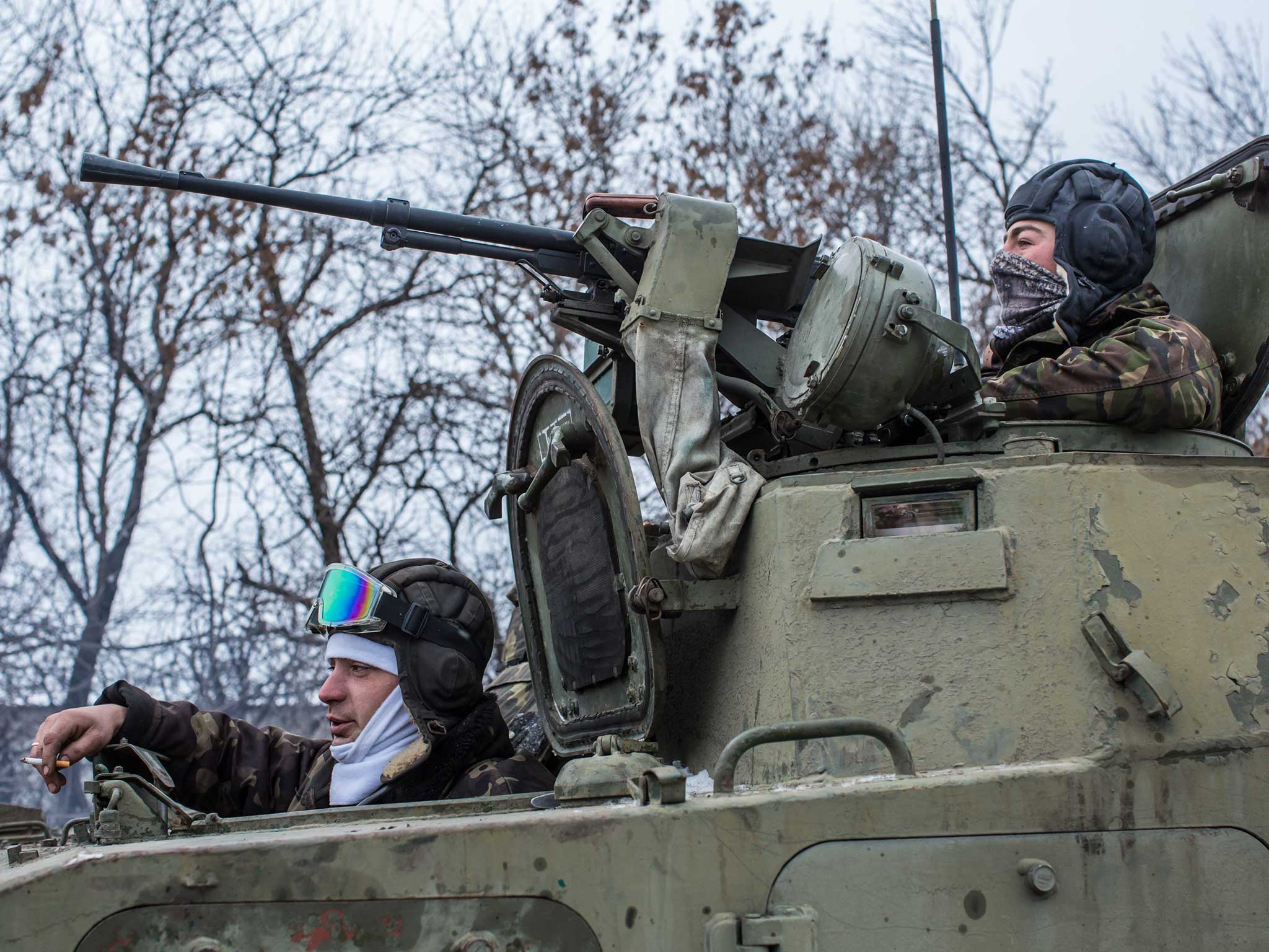 Ukrainian soldiers prepare to drive in the direction of the embattled town of Debaltseve on 16 February