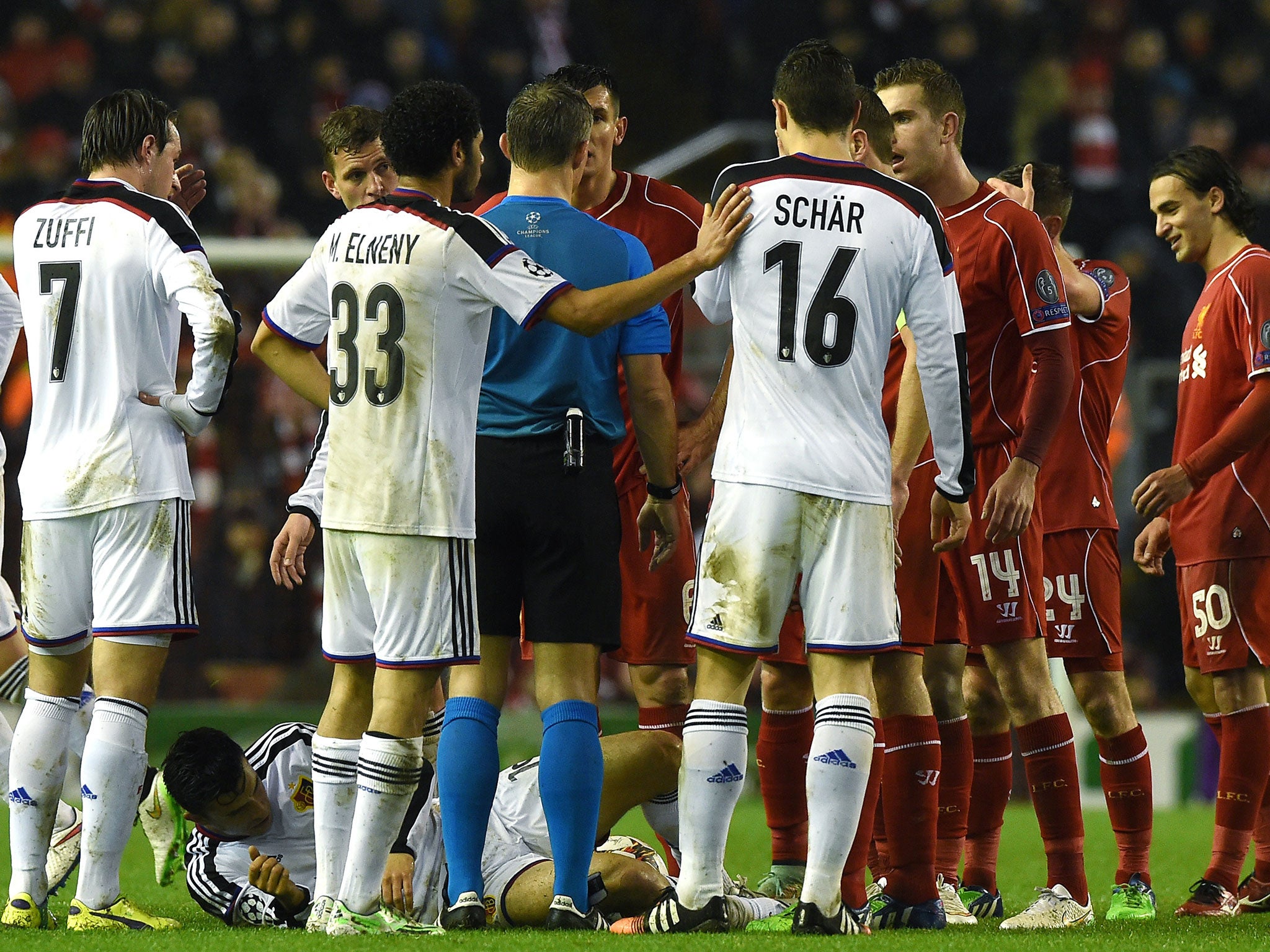 Referee Bjorn Kuipers splits the Liverpool and Basel players