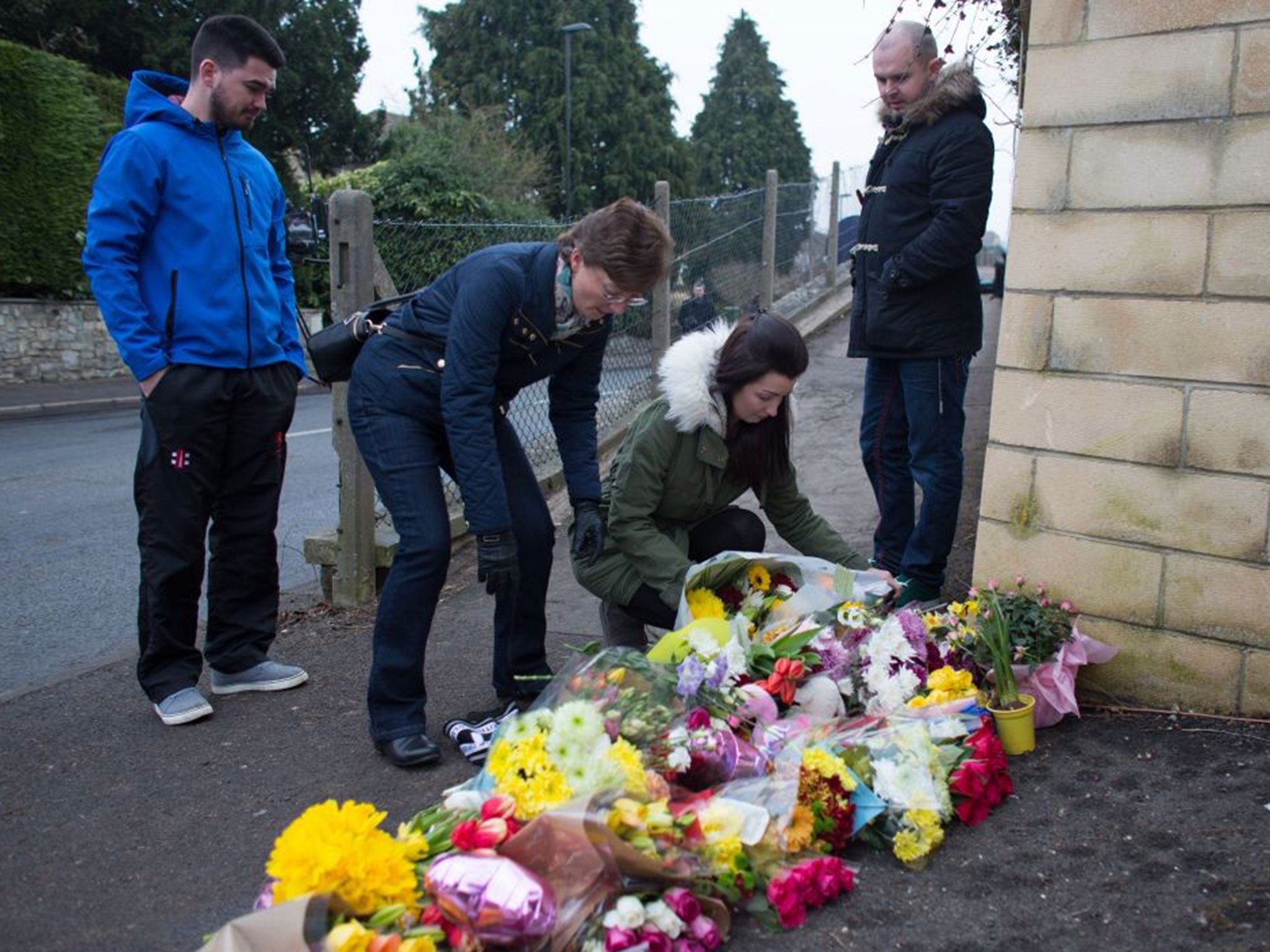 The family of Phil Allen, who died last night in a fatal road accident, arrive to leave flowers at the crash site on February 10 (PA)