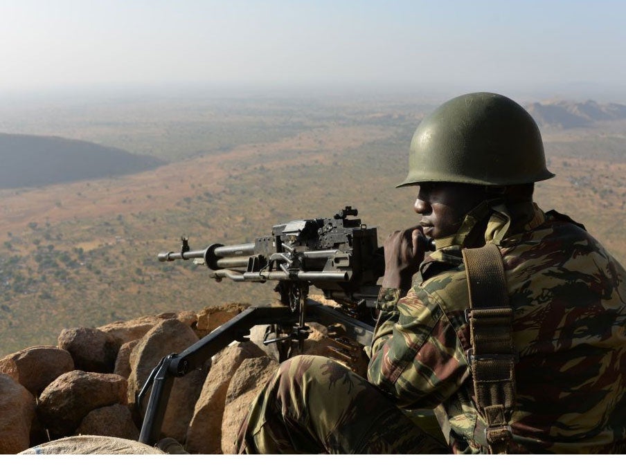 A Cameroon soldier holds a position on February 16, 2015 near the village of Mabass, northern Cameroon.