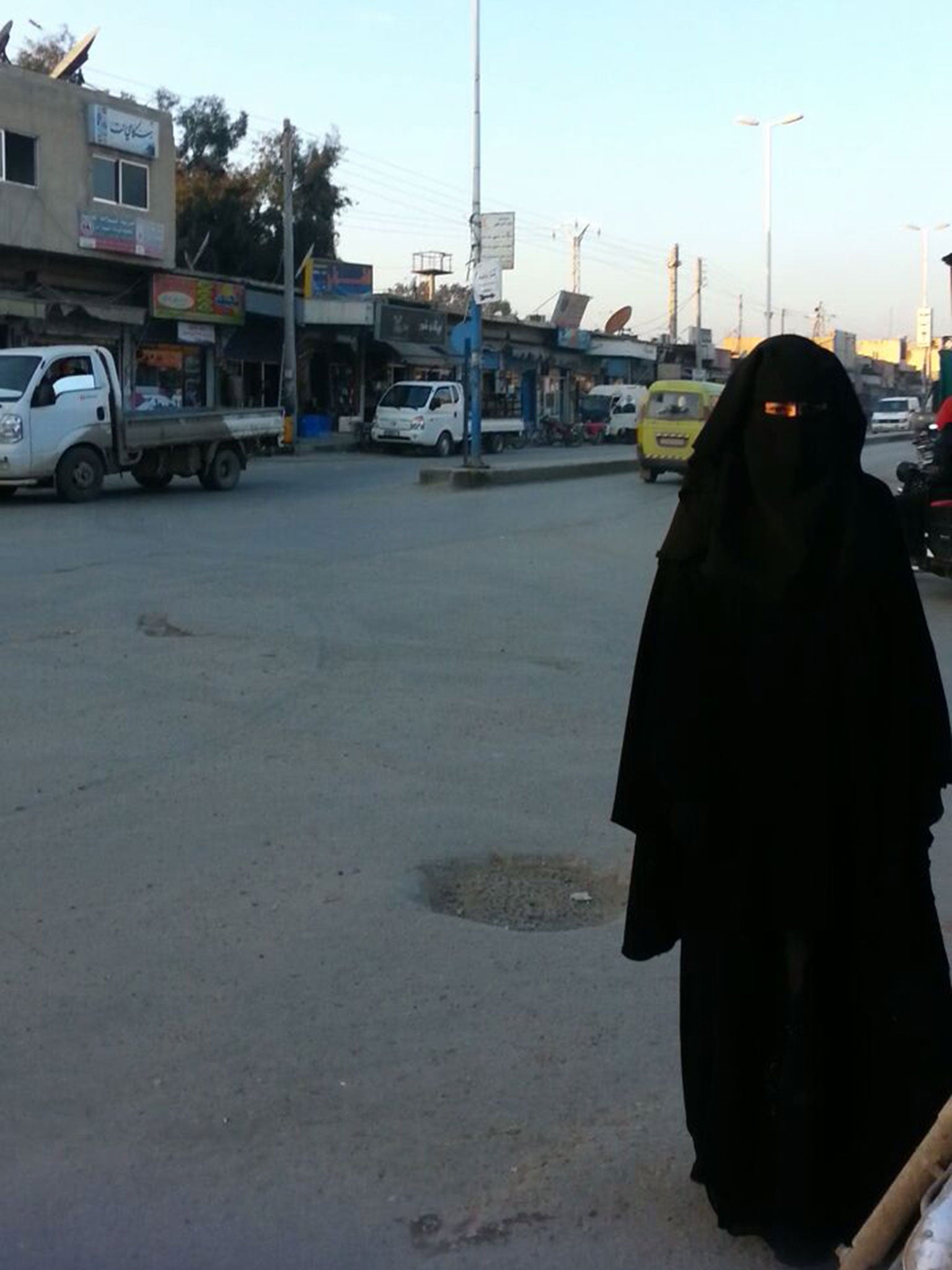 A woman is seen walking down a street in Raqqa (Pic: Raqqa is being Slaughtered Silently)