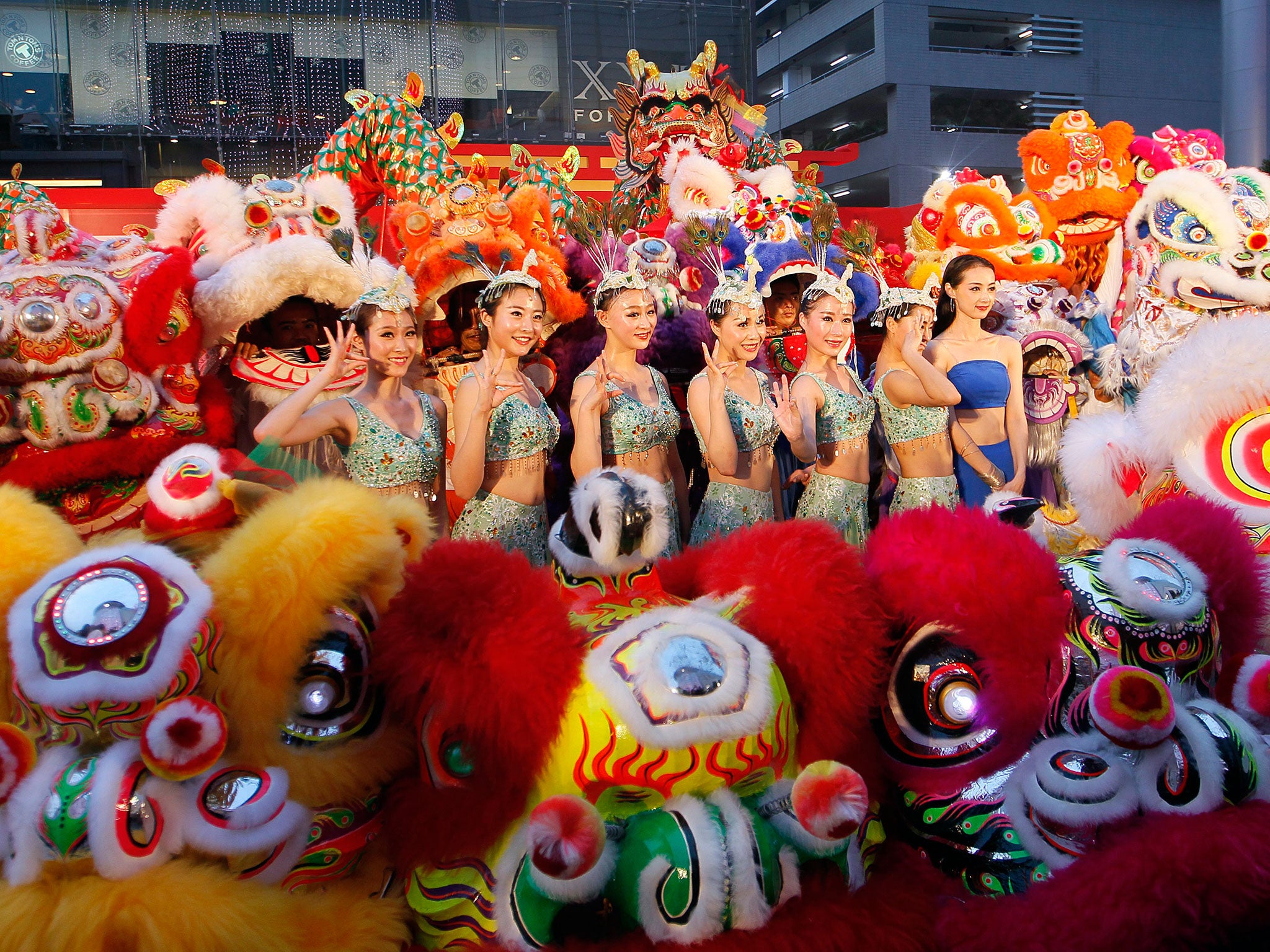 Chinese-Thai dancers pose for a family picture after performing a Dragon Dance on the eve of the Chinese Lunar New Year in Bangkok, Thailand