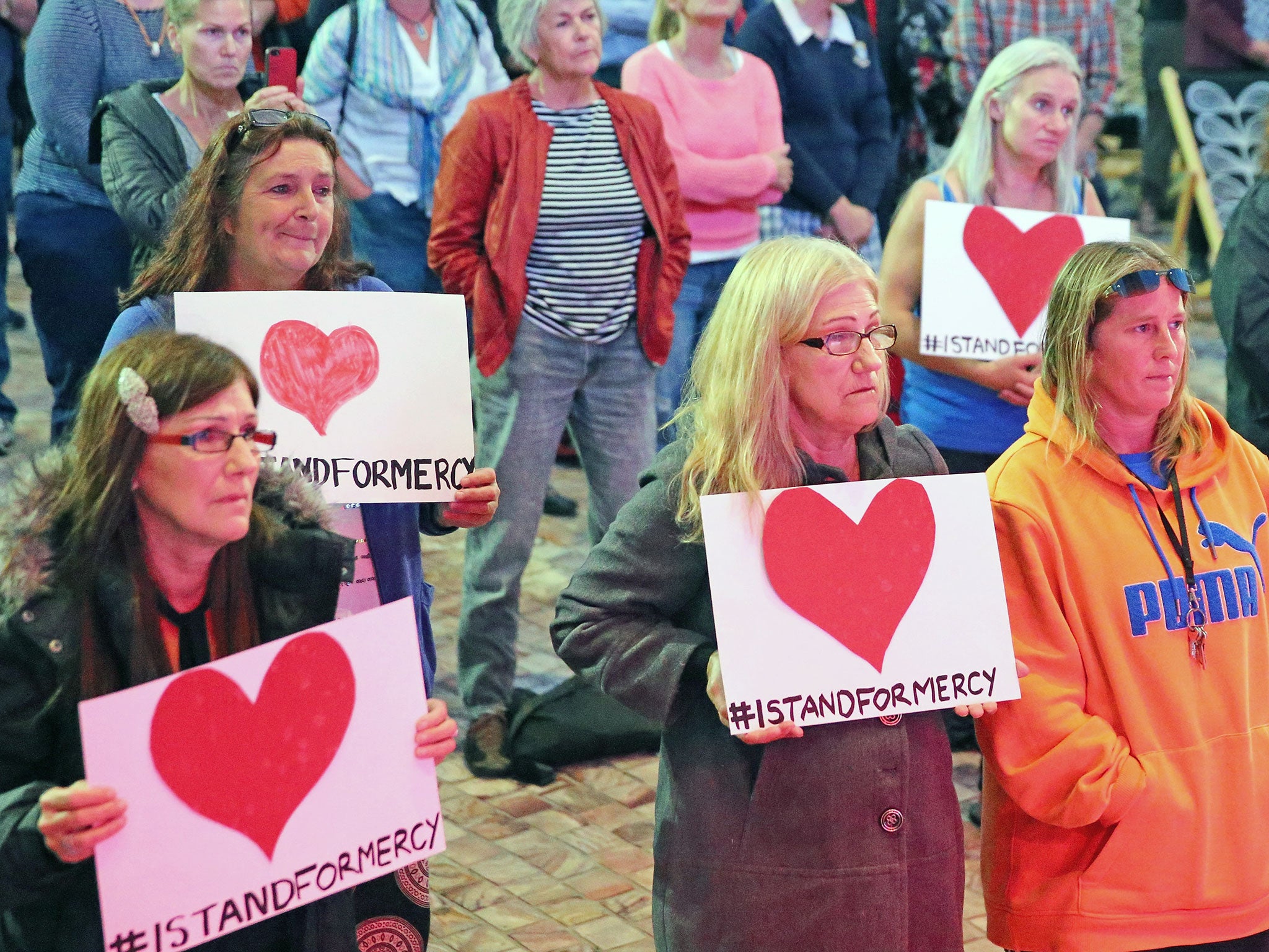 People hold signs during a vigil on Wednesdy for the two prisoners at Federation Square on in Melbourne, Australia. (Getty Images)