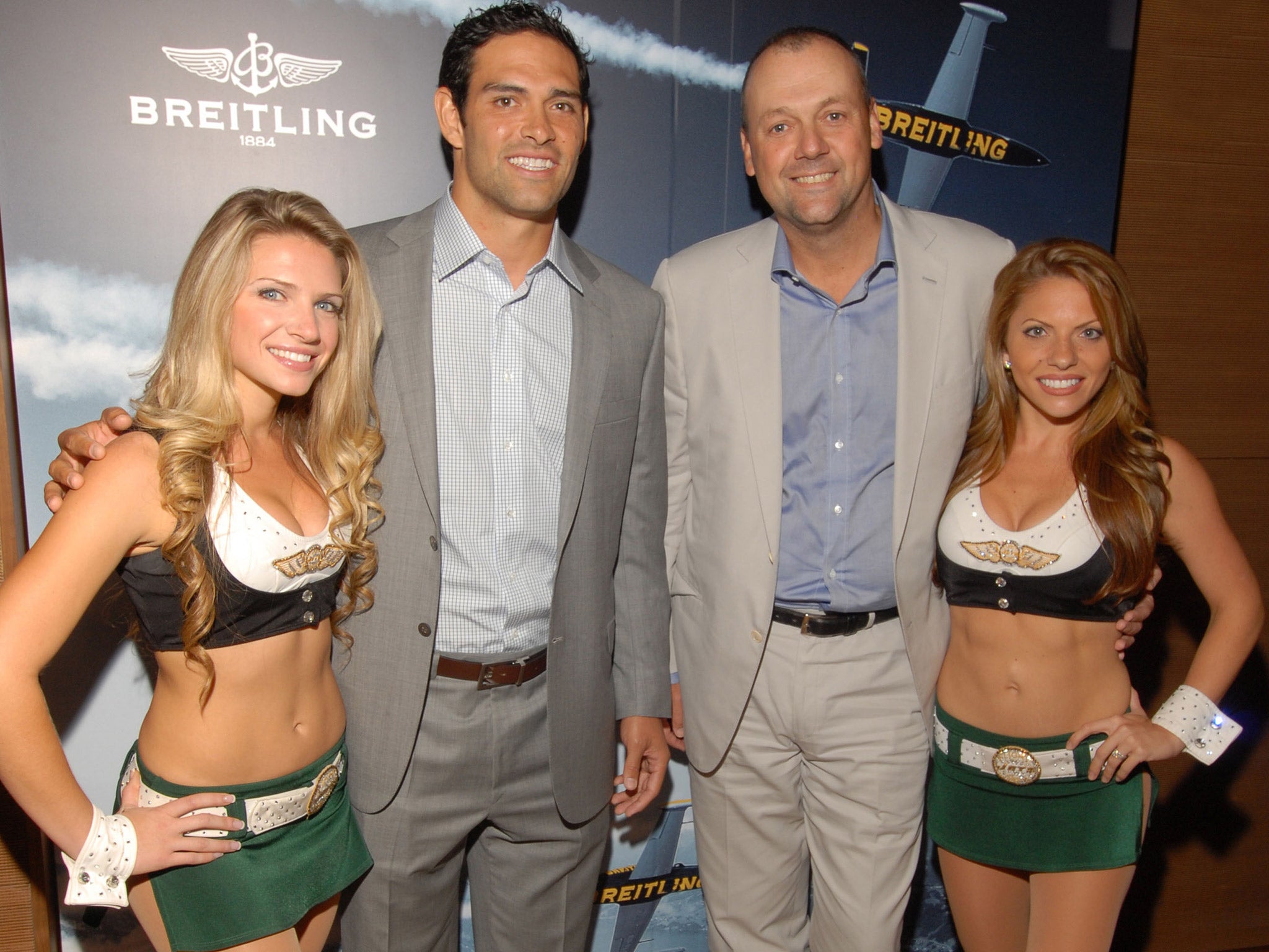 Breitling president Thierry Prissert (second from right) poses with NFL quarterback Mark Sanchez and two cheerleaders in New York in 2012