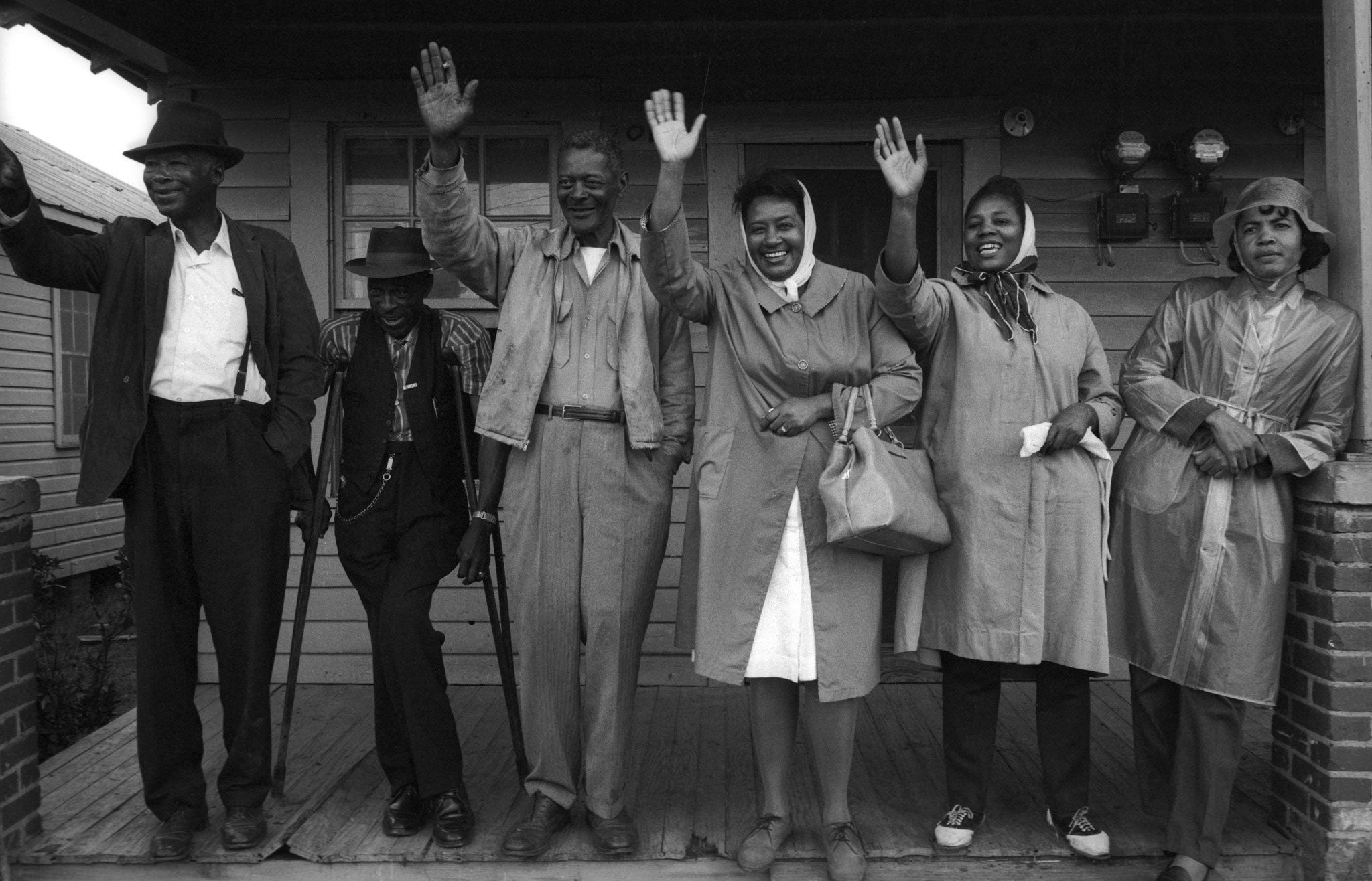 Members of King's Southern Christian Leadership Conference greet the city fathers of Montgomery on the balcony of the Jefferson Davis Hotel