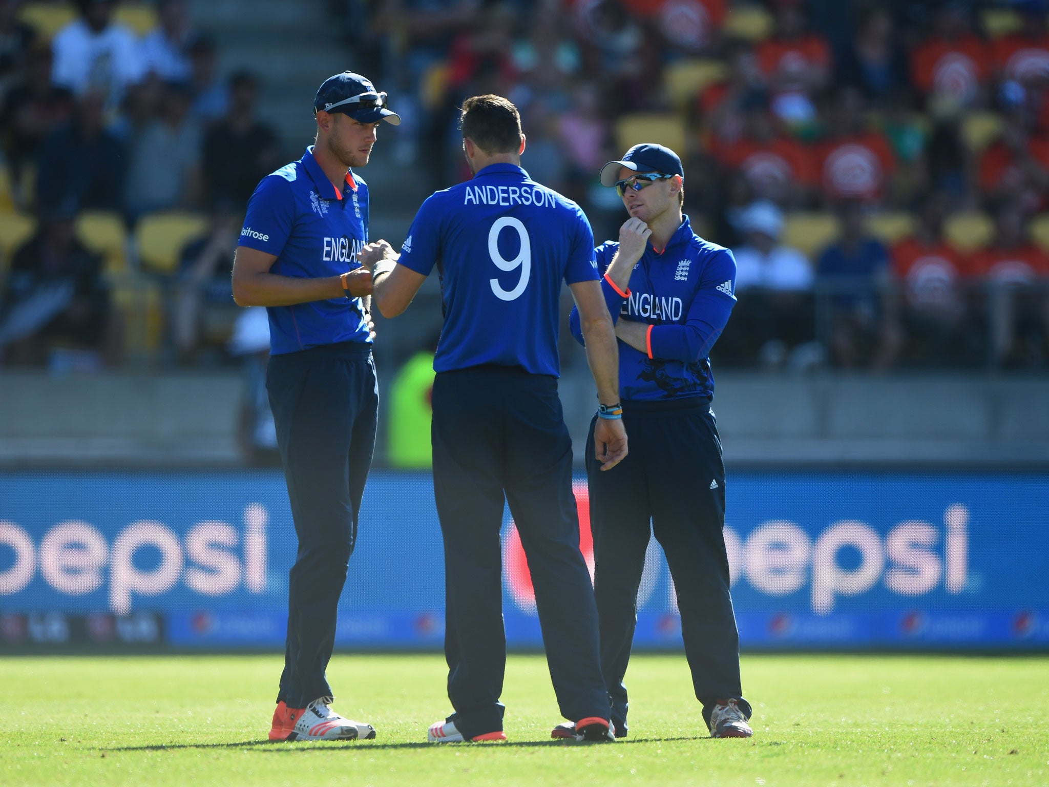 Stuart Broad and Eoin Morgan consult bowler James Anderson