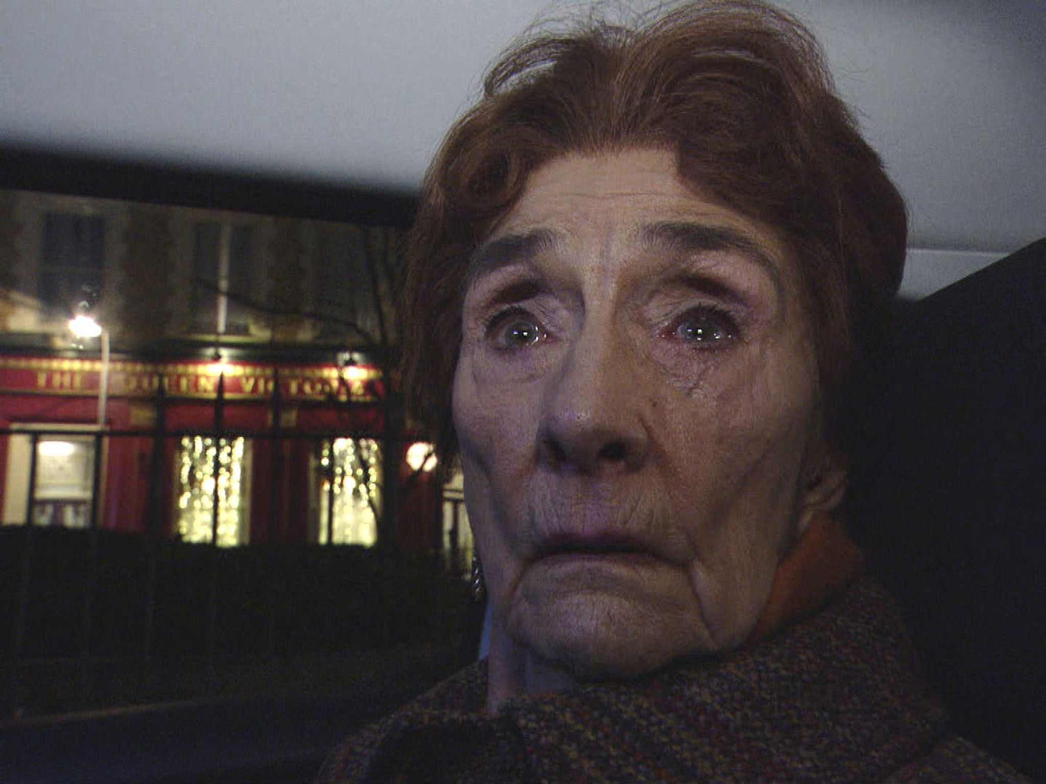 Dot Cotton is taken away in a police car on EastEnders