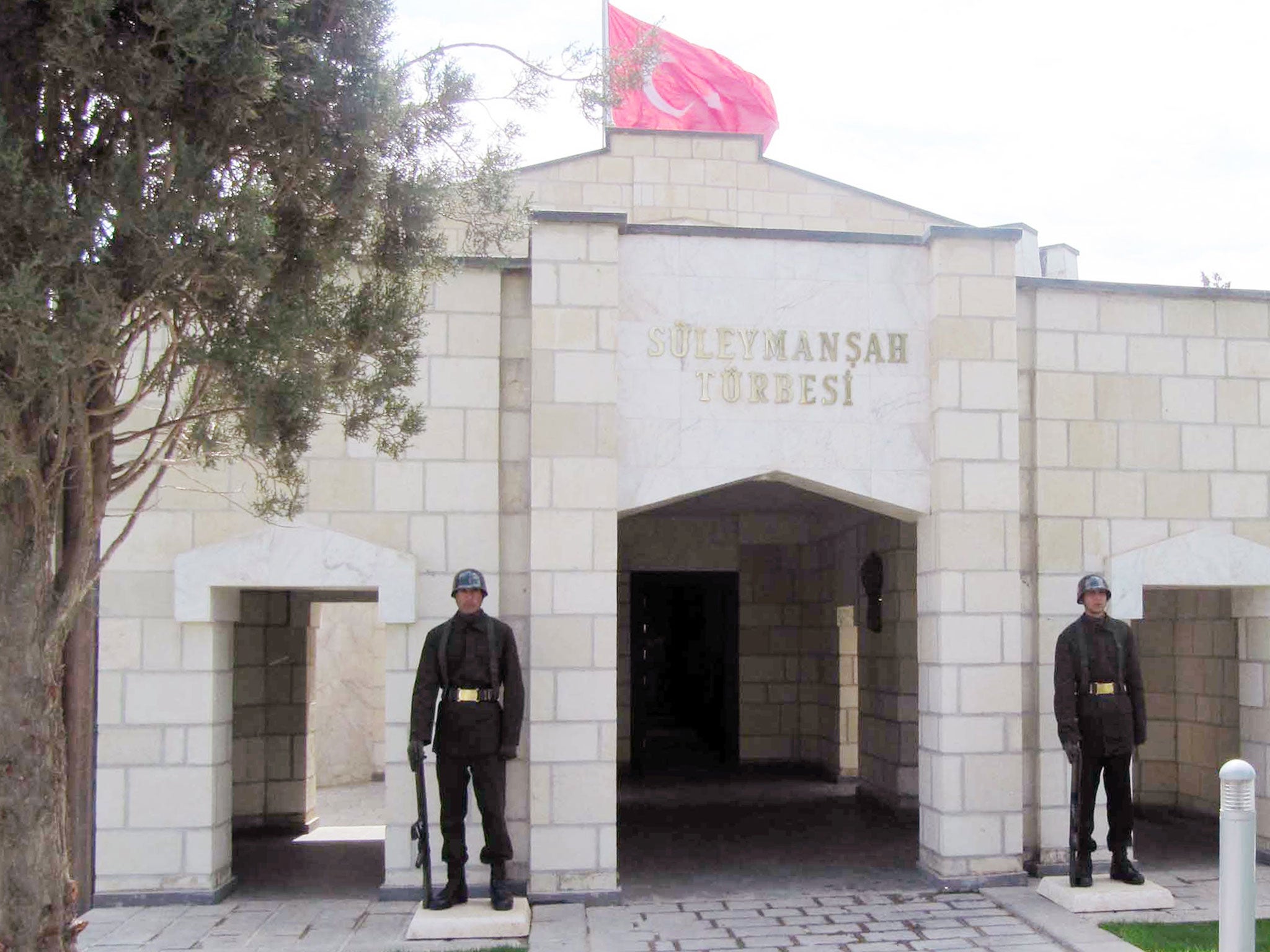 File: Turkish soldiers stand guard at the entrance of the memorial site of Suleyman Shah, in Syria (AP)