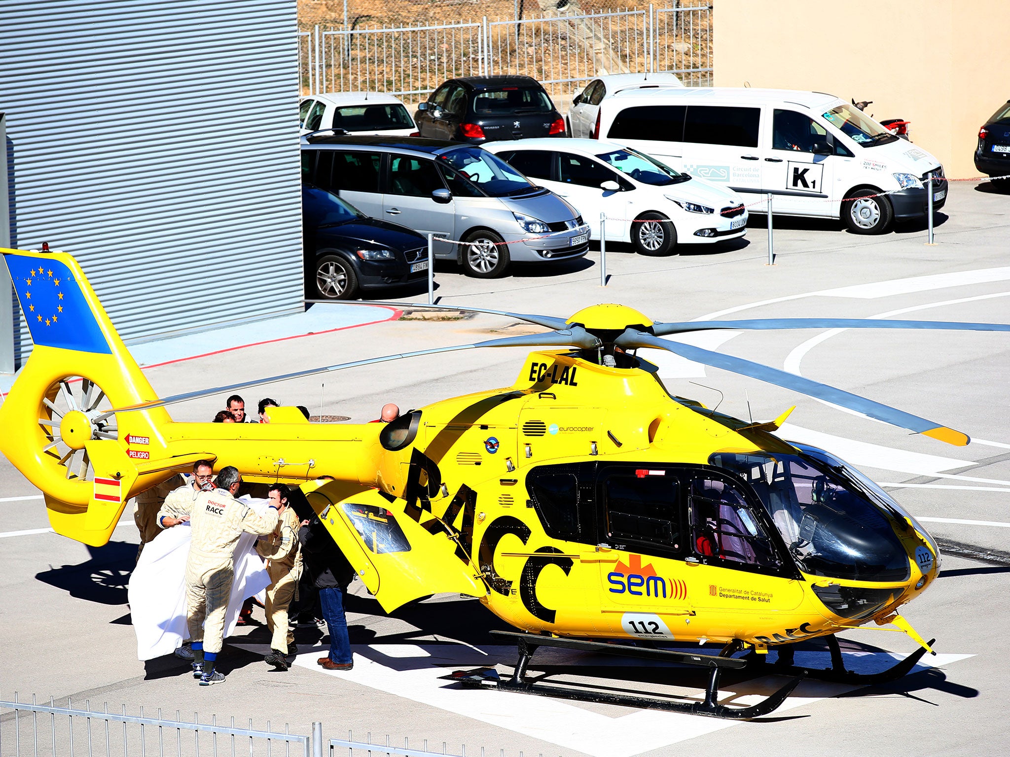 Alonso is transferred from the medical centre to the helicopter after crashing