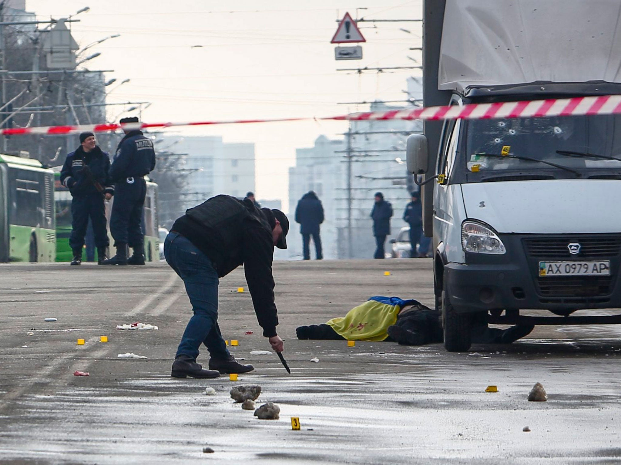 Ukrainian investigators at the site of an explosion in Kharkiv