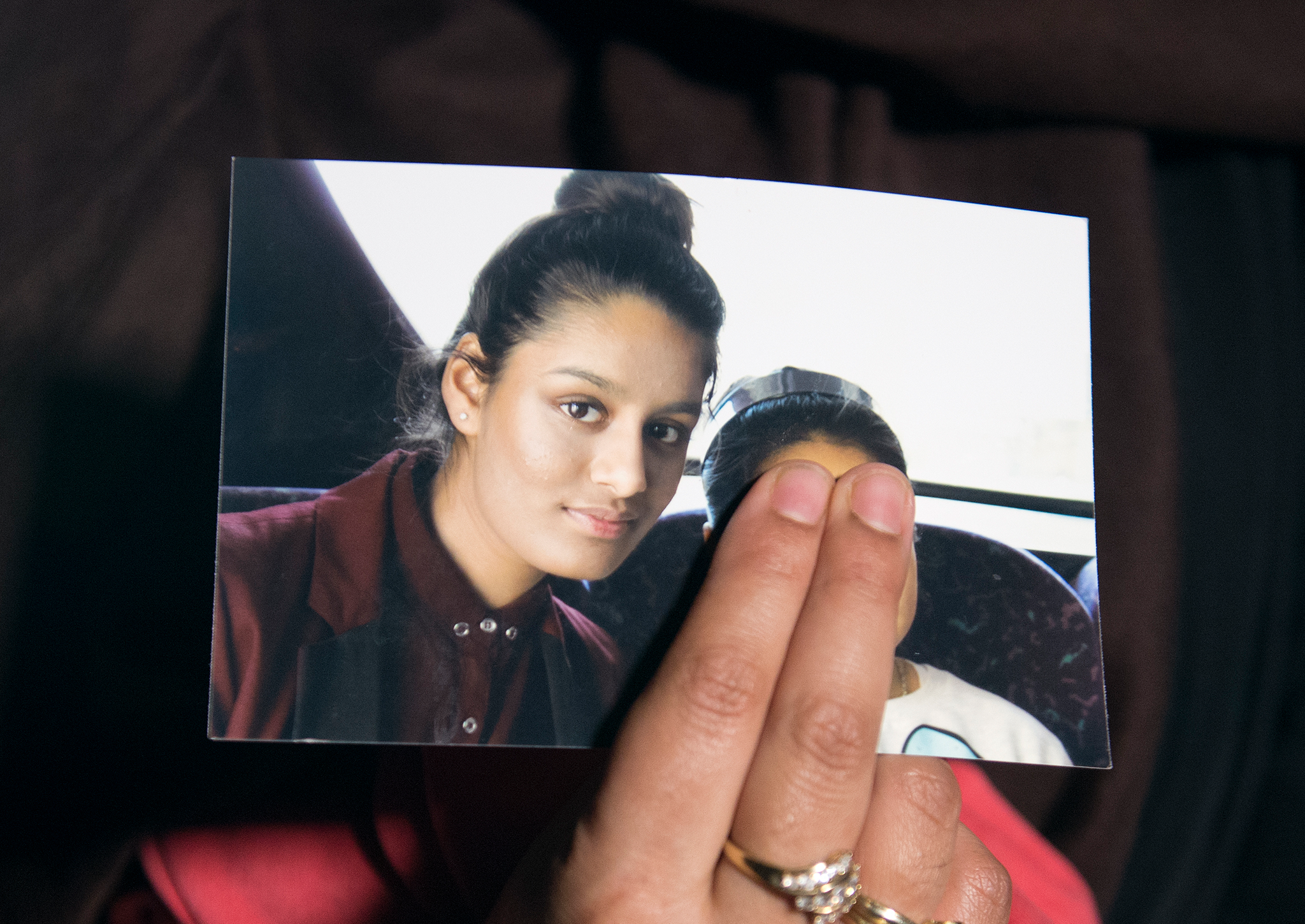 Renu Begum, eldest sister of Shamima Begum, 15, holds her sister's photo