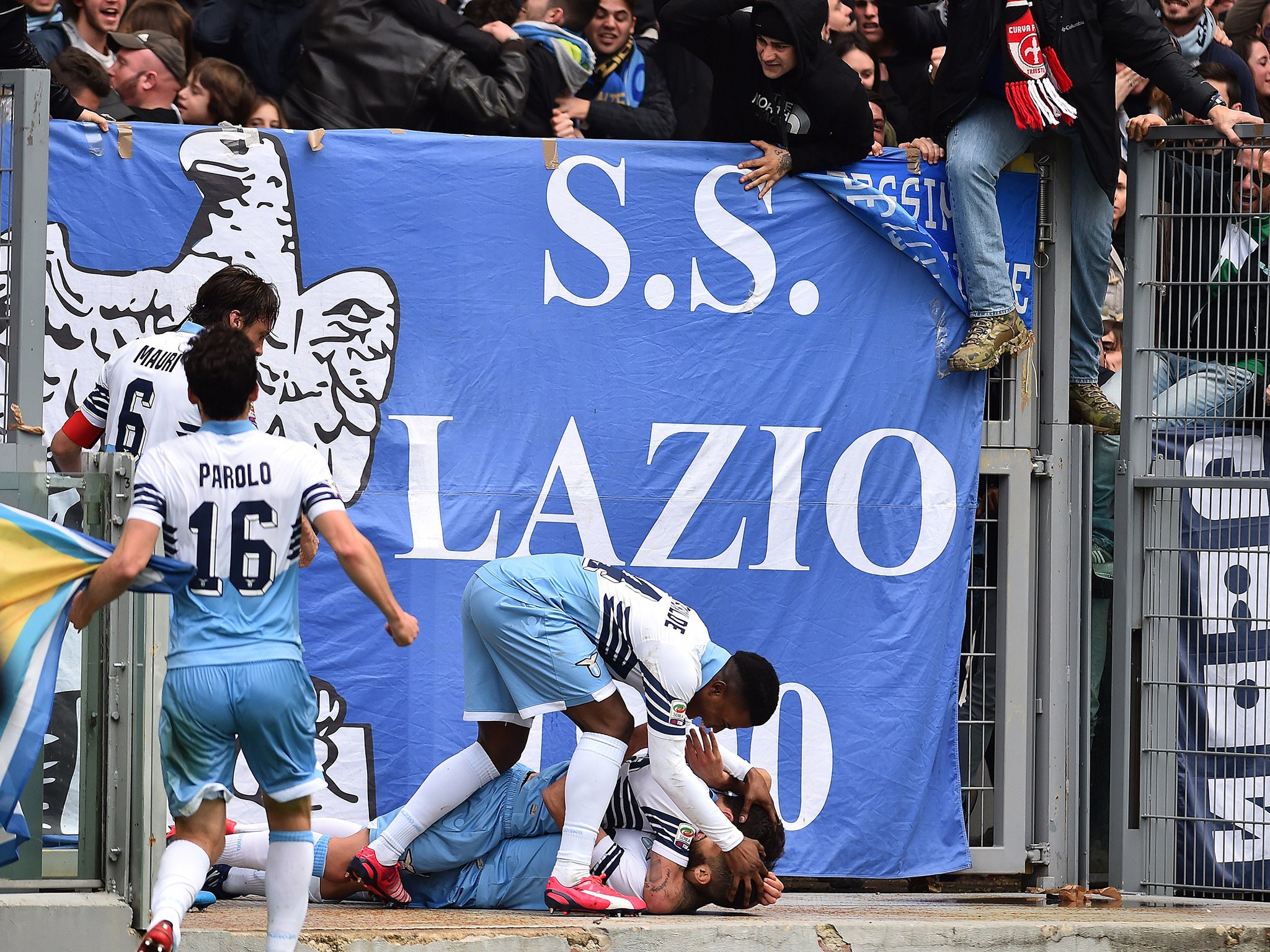 Antonio Candreva on the floor after sliding into hoardings in celebration