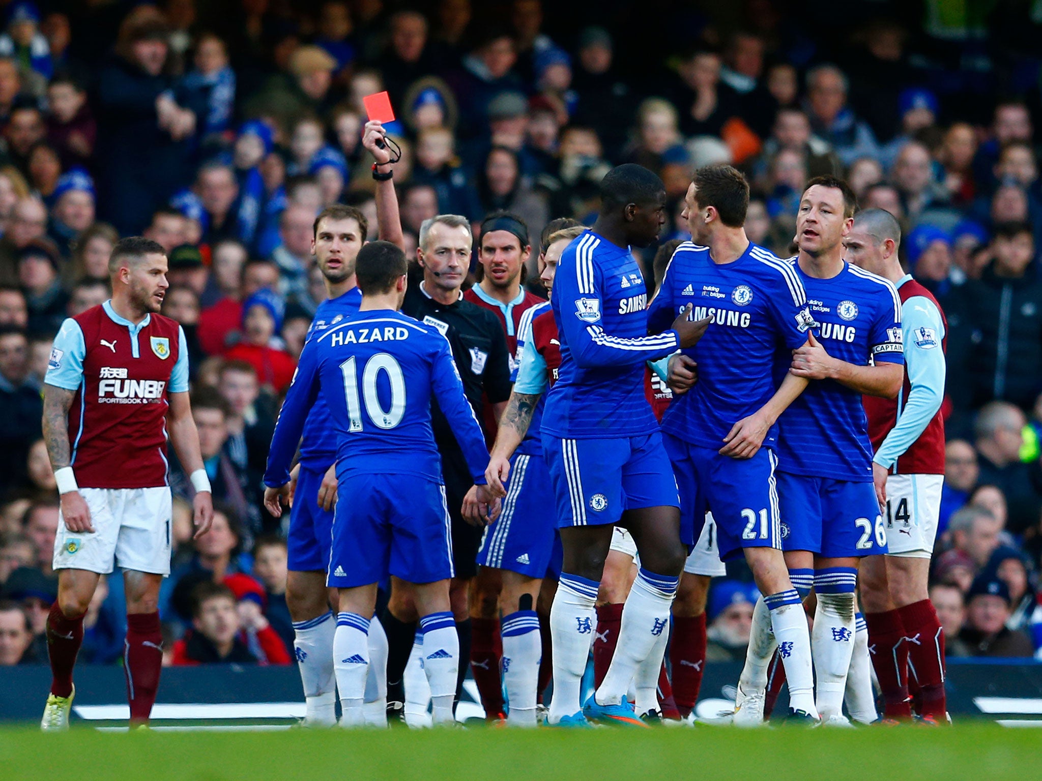 Referee Martin Atkinson shows Nemanja Matic a red card