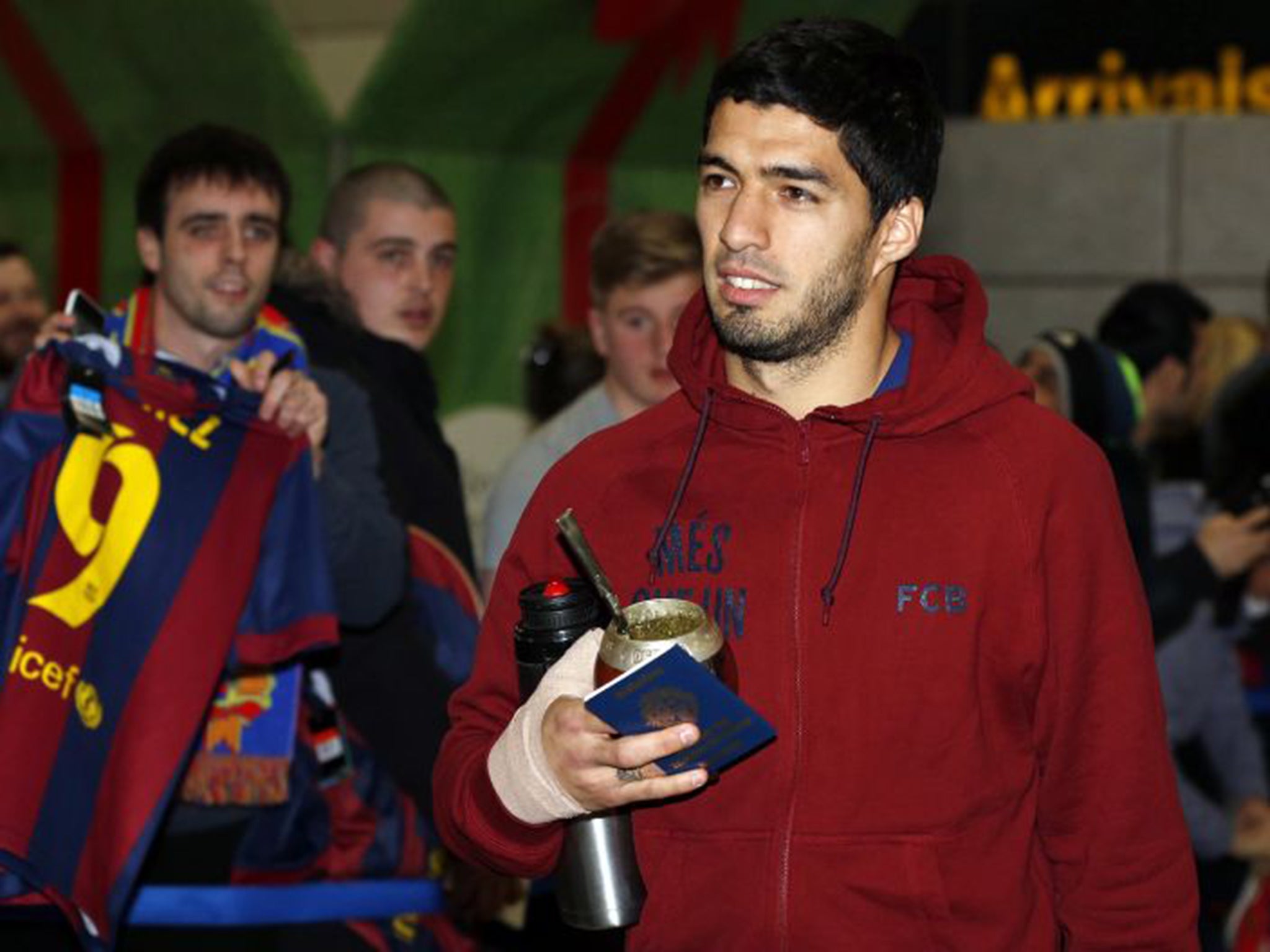 Barcelona’s Luis Suarez returns to English soil yesterday as he arrives at Manchester Airport ahead of his side’s Champions League tie against City on Tuesday night