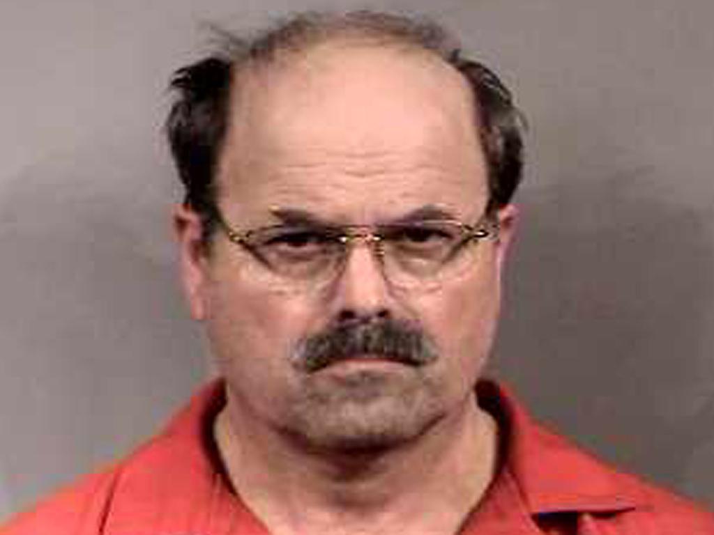 BTK murder suspect Dennis Rader stands for a mug shot released February 27, 2005 in Sedgwick County, Kansas