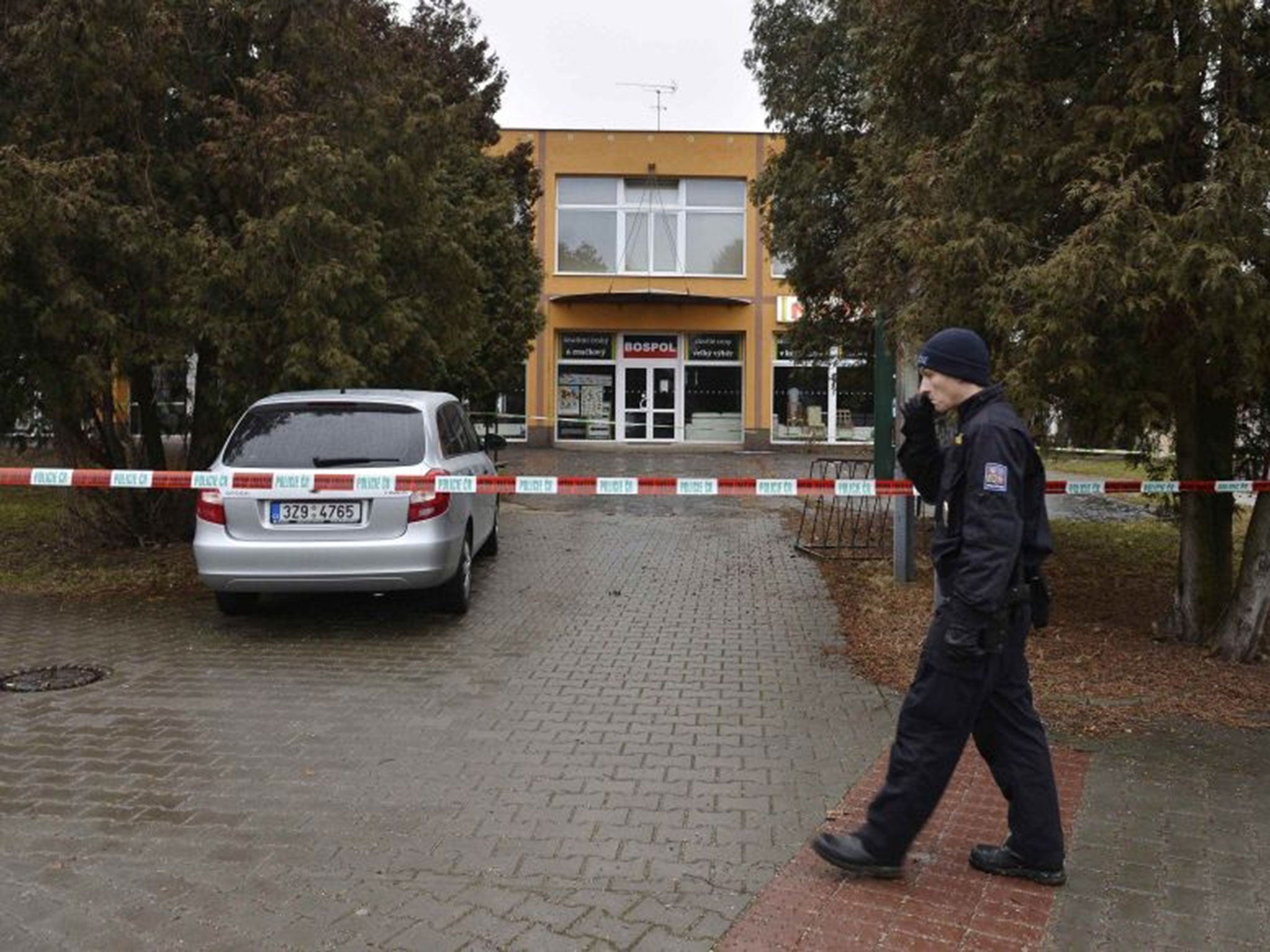 A police officer patrols near a restaurant where a gunman opened fire in Uhersky