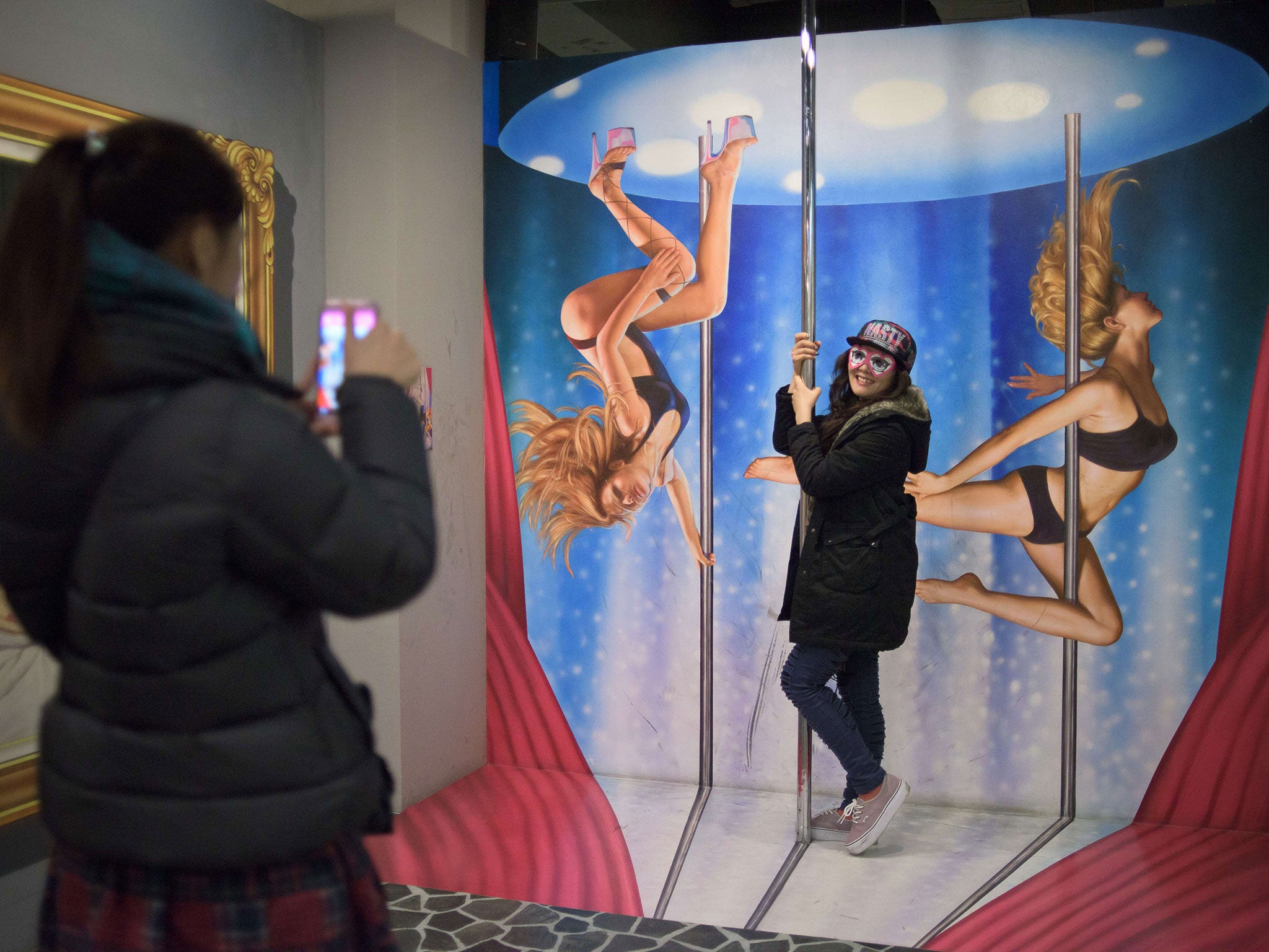 Visitors pose with exhibits displayed at a 'love museum' in Seoul. A 62-year-old law banning adultery in South Korea has been abolished by the highest court in the land