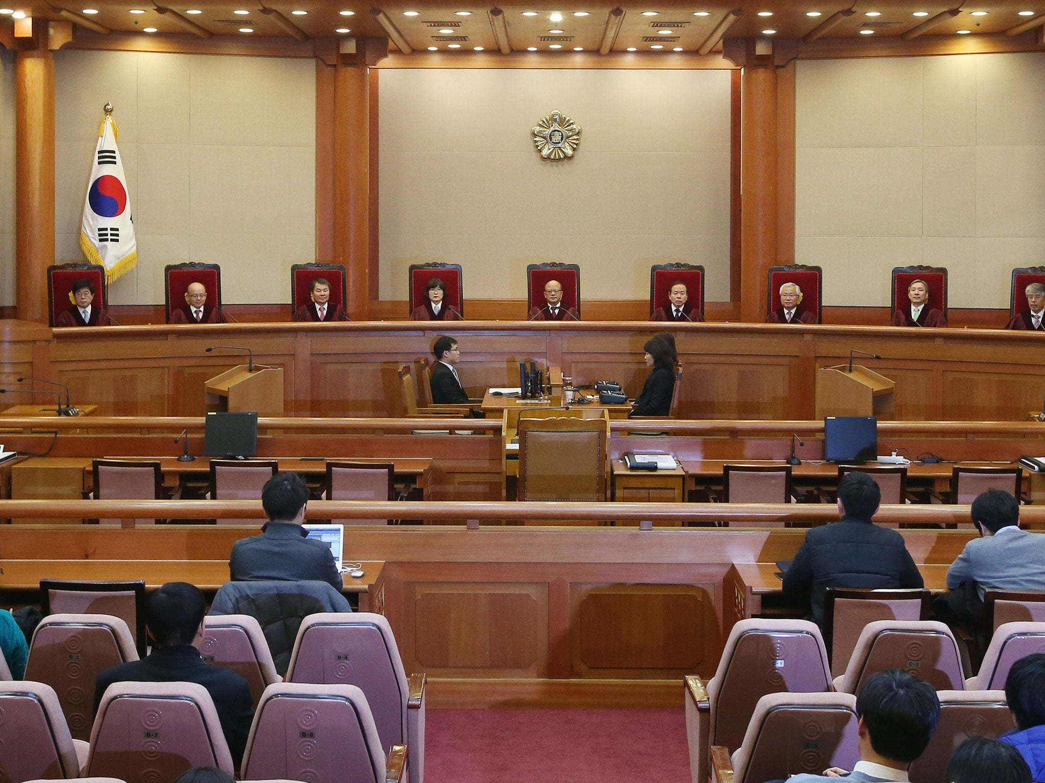 Judges of South Korea's Constitutional Court prepare to deliver a ruling over a controversial adultery law