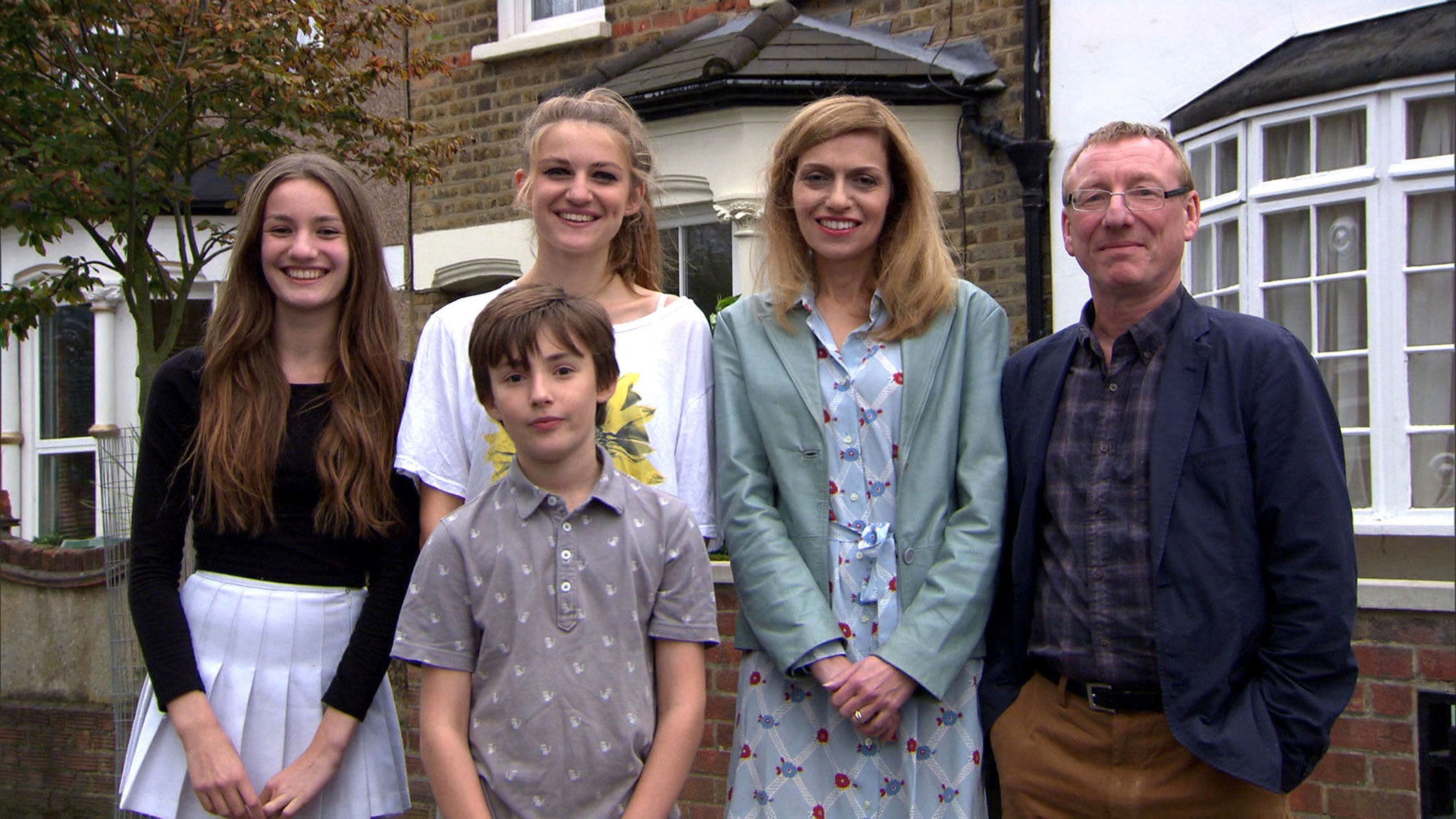 The Robshaws in their 1960s kitchen, with its luminous sky-blue walls and radioactive yellow curtains (BBC)