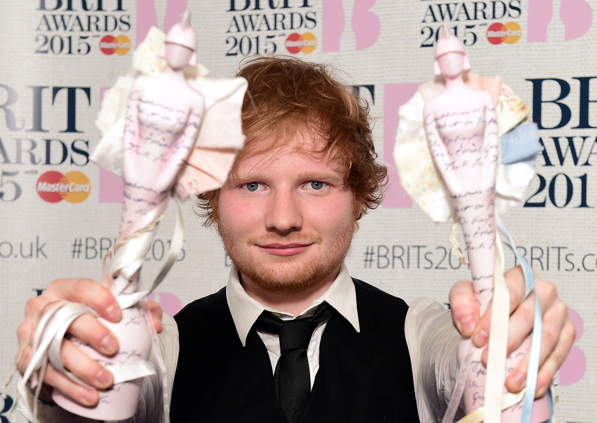 Ed Sheeran shows off his awards at the Brit Awards 2015