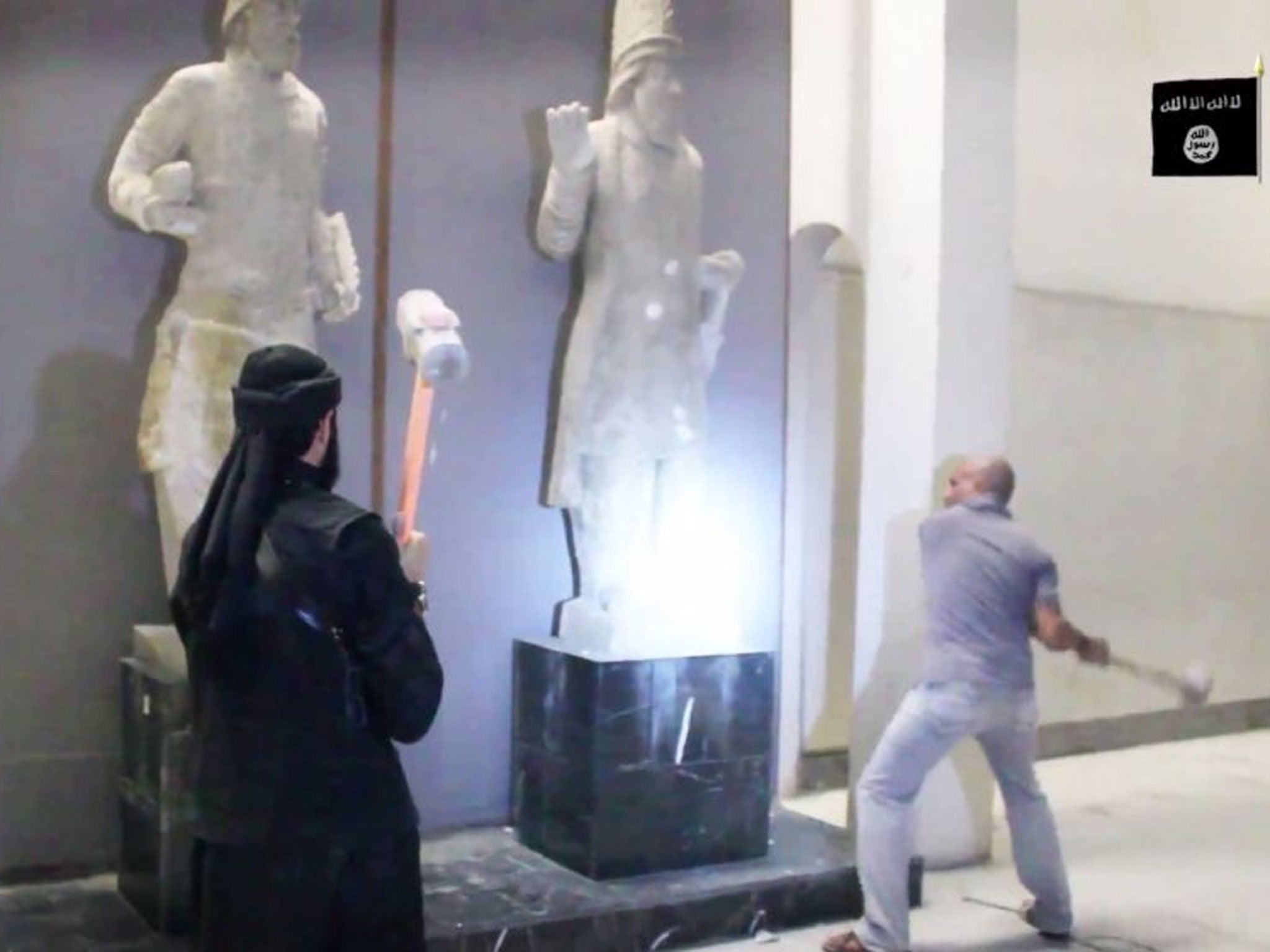 Isis militants attack ancient artifacts with sledgehammers in the Ninevah Museum in Mosul, Iraq (AP)