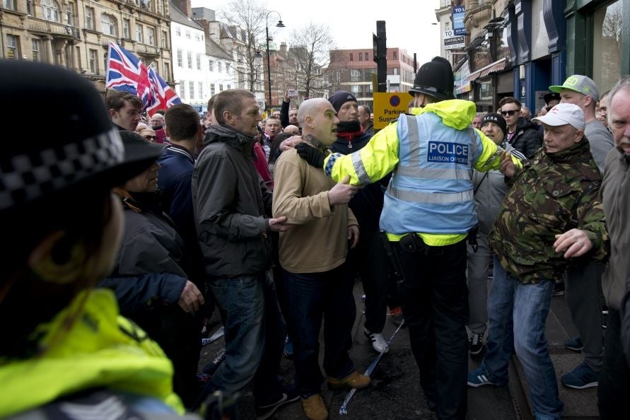 Police officers break up a fight during the demonstration