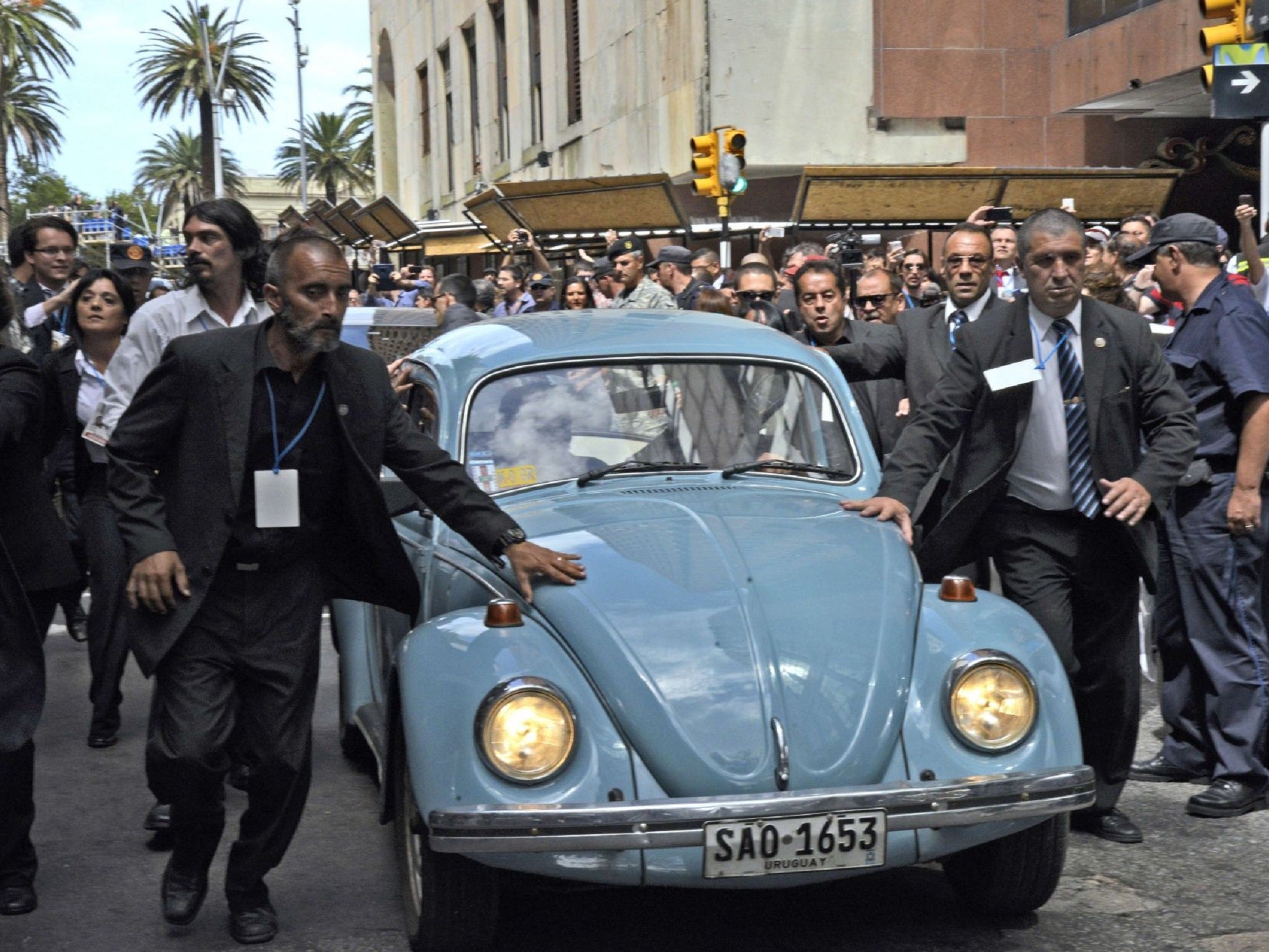 Mujica driving his iconic blue 1987 VW Beetle