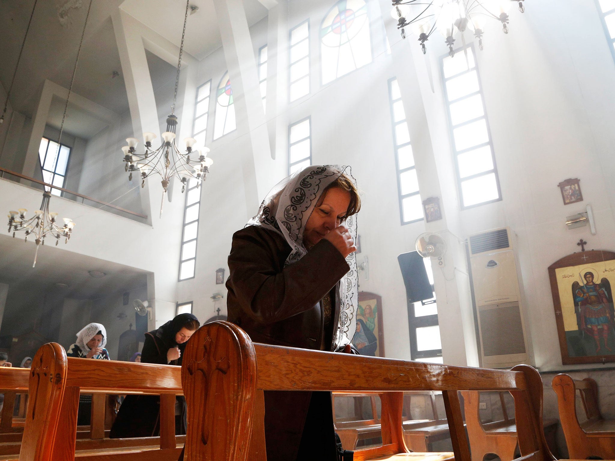 An Assyrian woman attends a mass in solidarity with the Assyrians abducted by Islamic State fighters in Syria